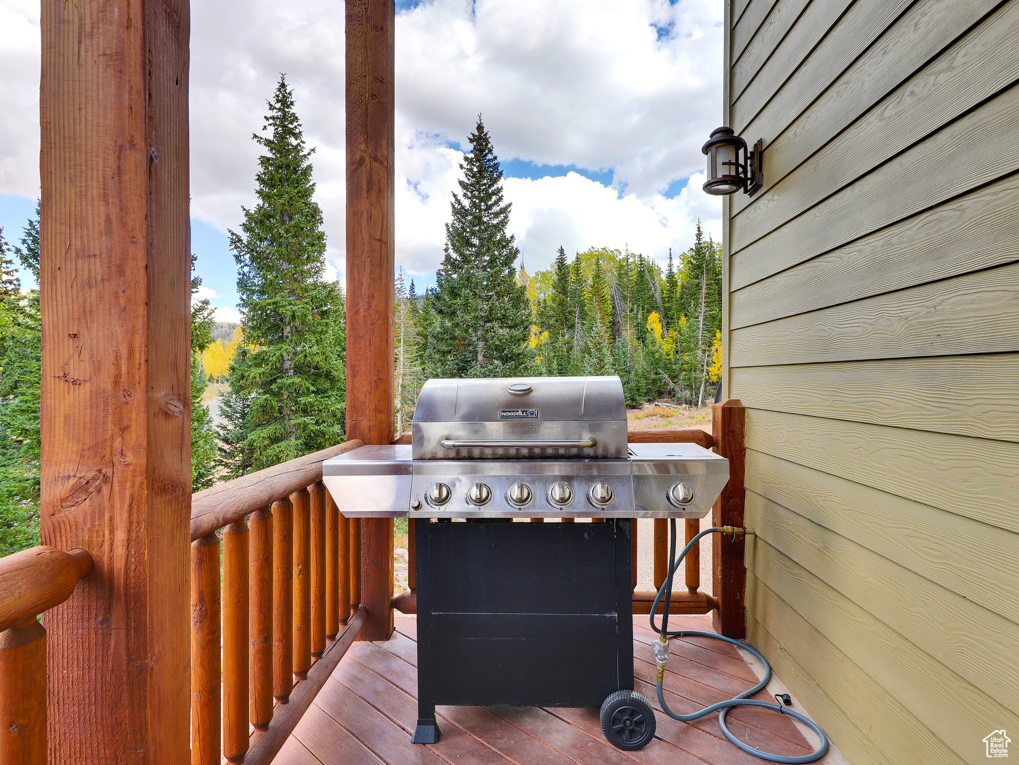 Wooden terrace featuring area for grilling