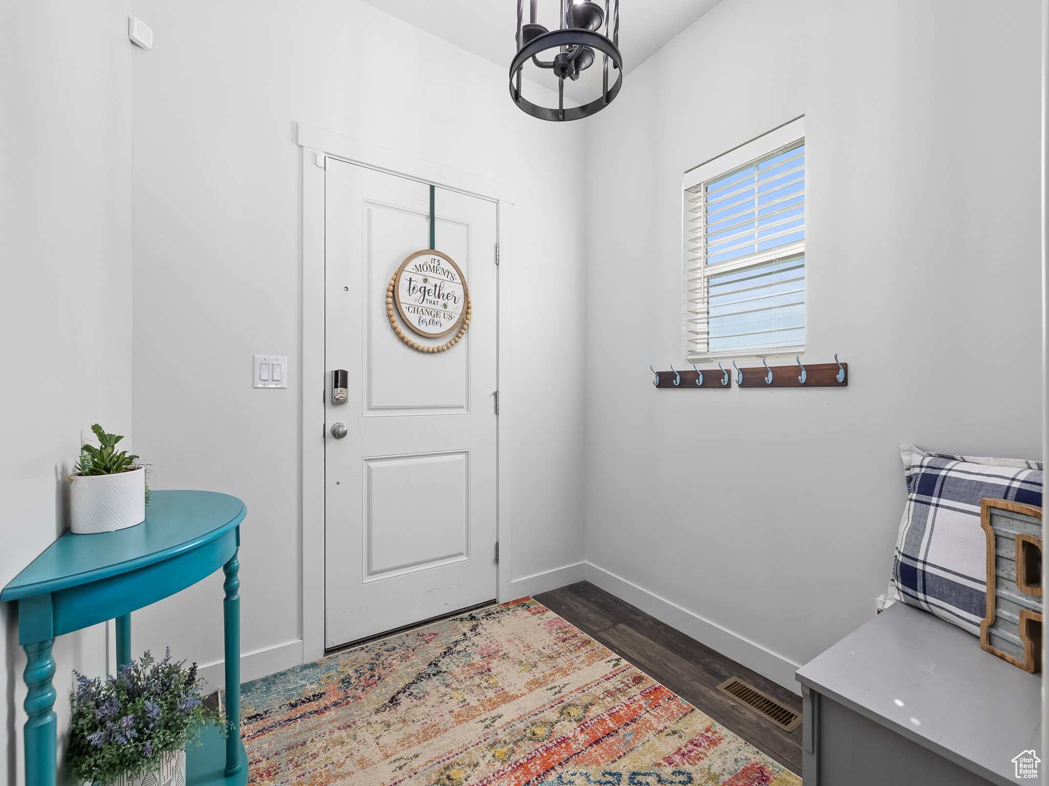 Entrance foyer featuring dark wood finished floors, baseboards, and visible vents