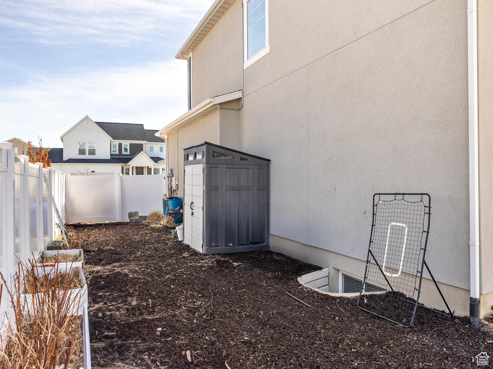 View of yard featuring an outbuilding, a fenced backyard, and a storage shed