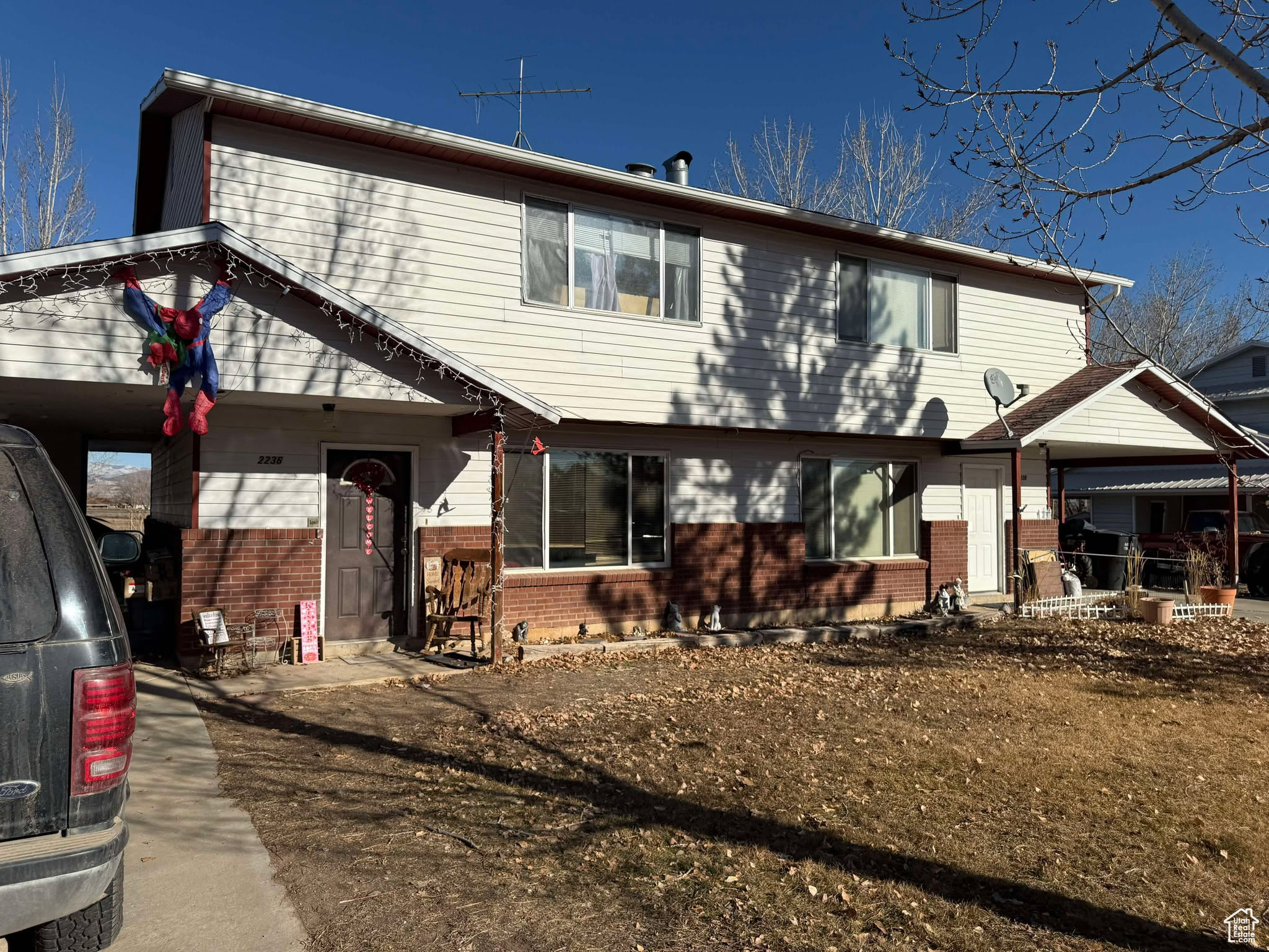 Back of house featuring brick siding