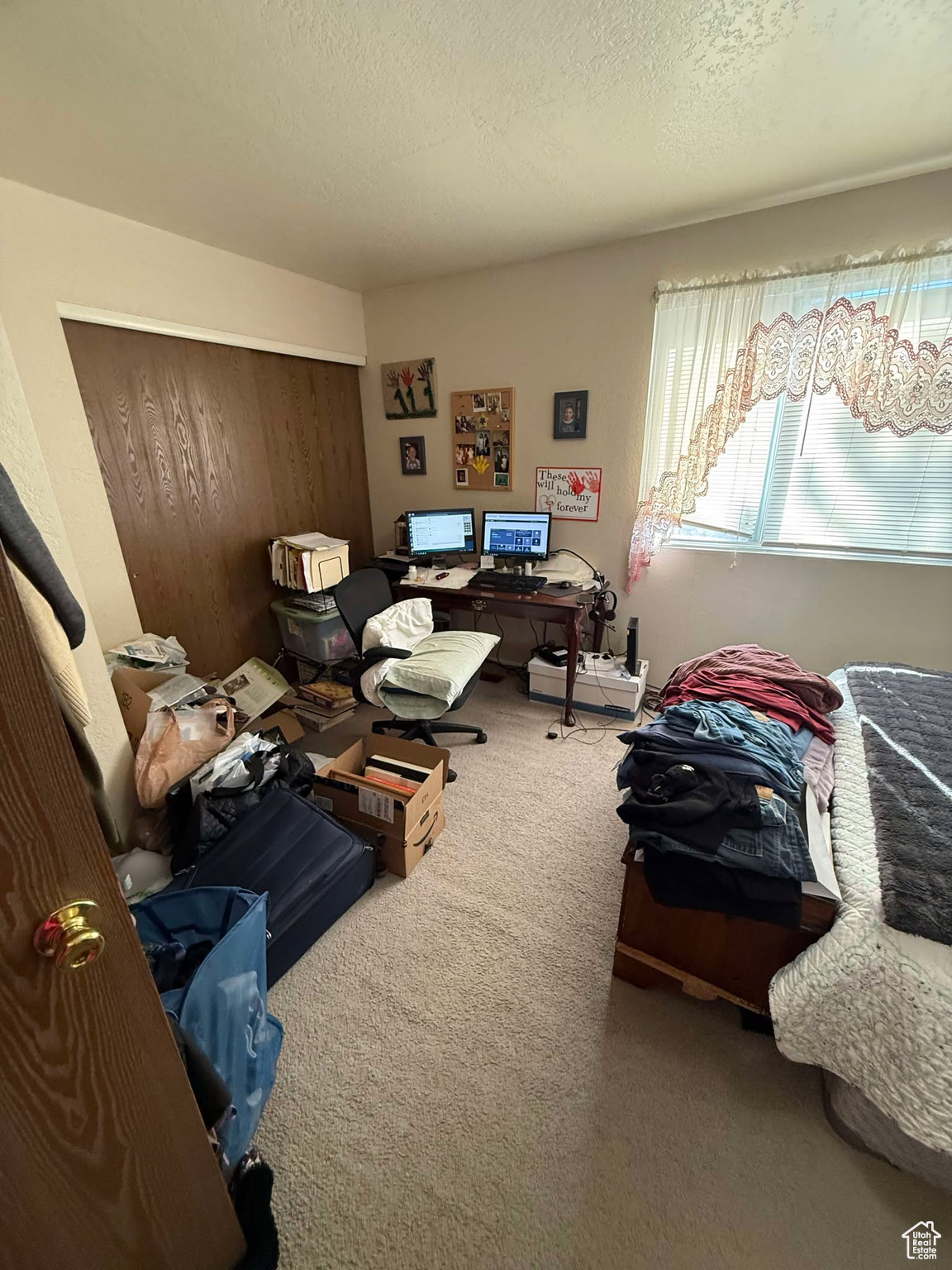Carpeted bedroom featuring a closet and a textured ceiling