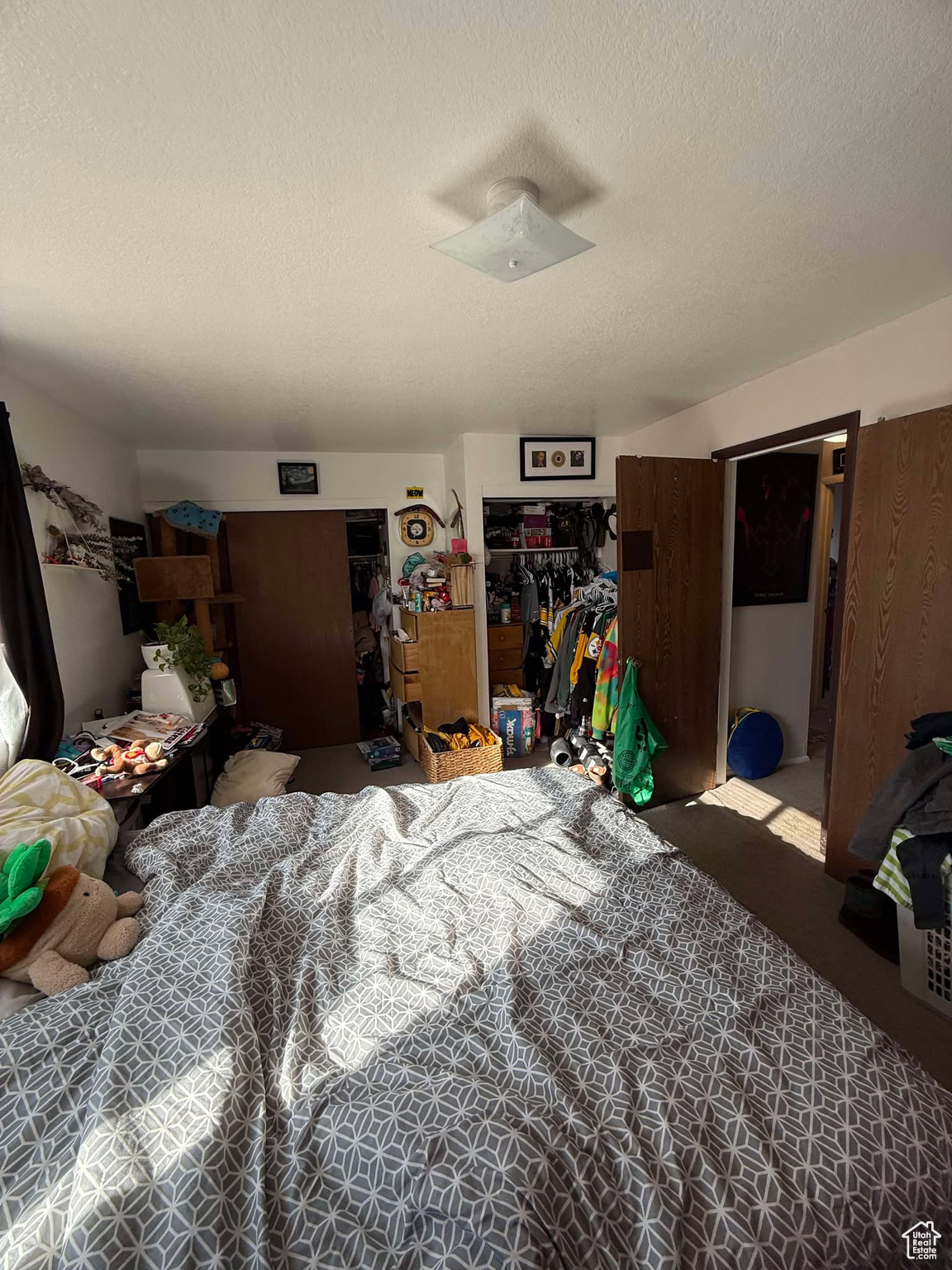 Bedroom featuring a closet and a textured ceiling
