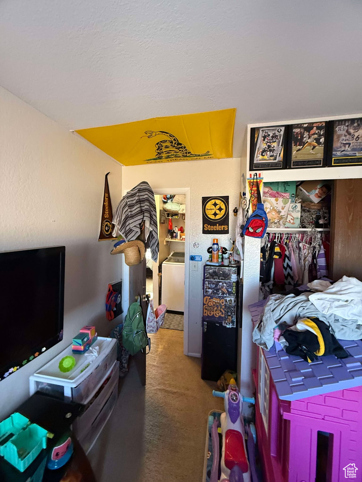 Bedroom featuring washer / dryer and carpet flooring