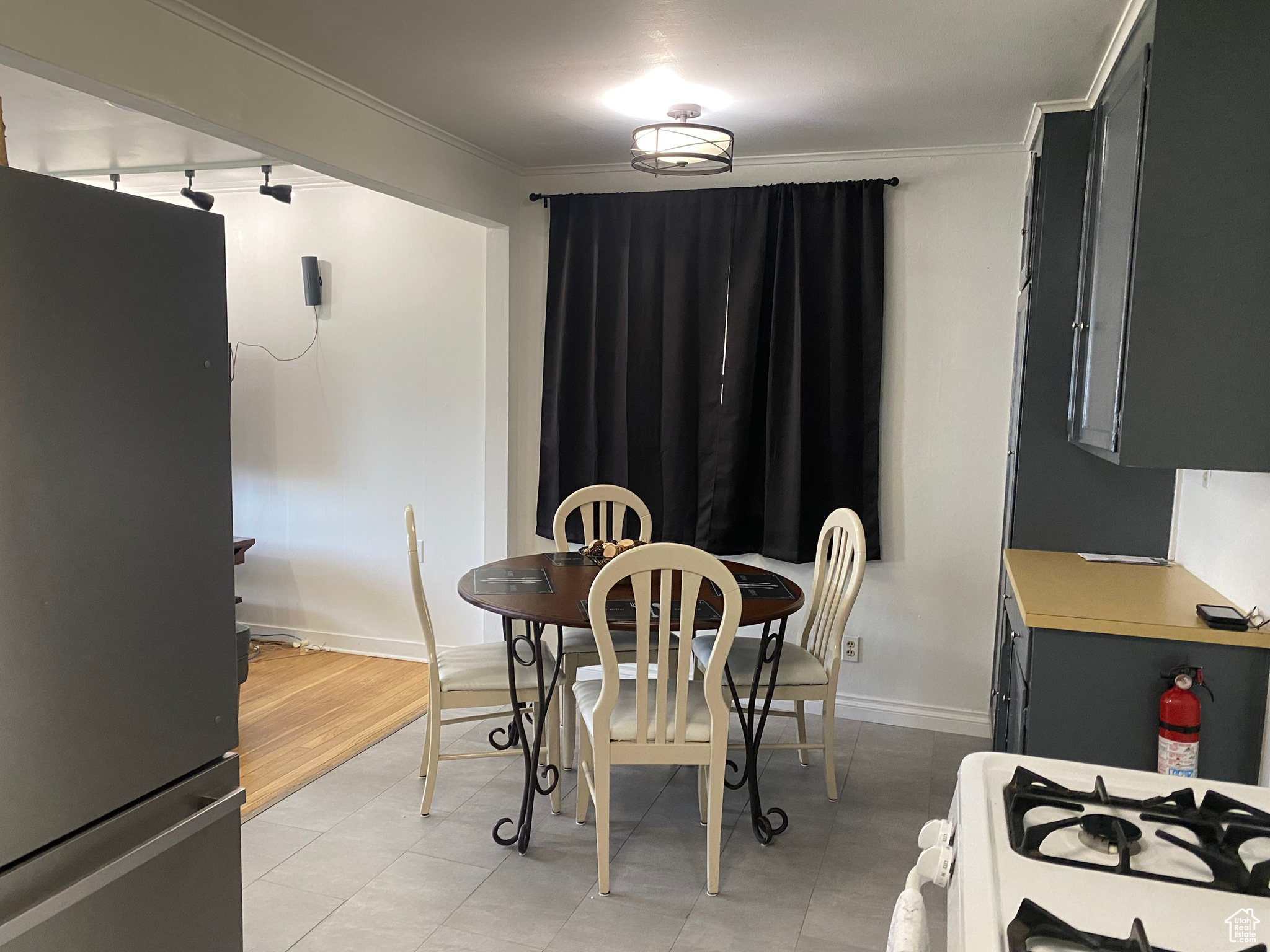 Dining area with baseboards and crown molding