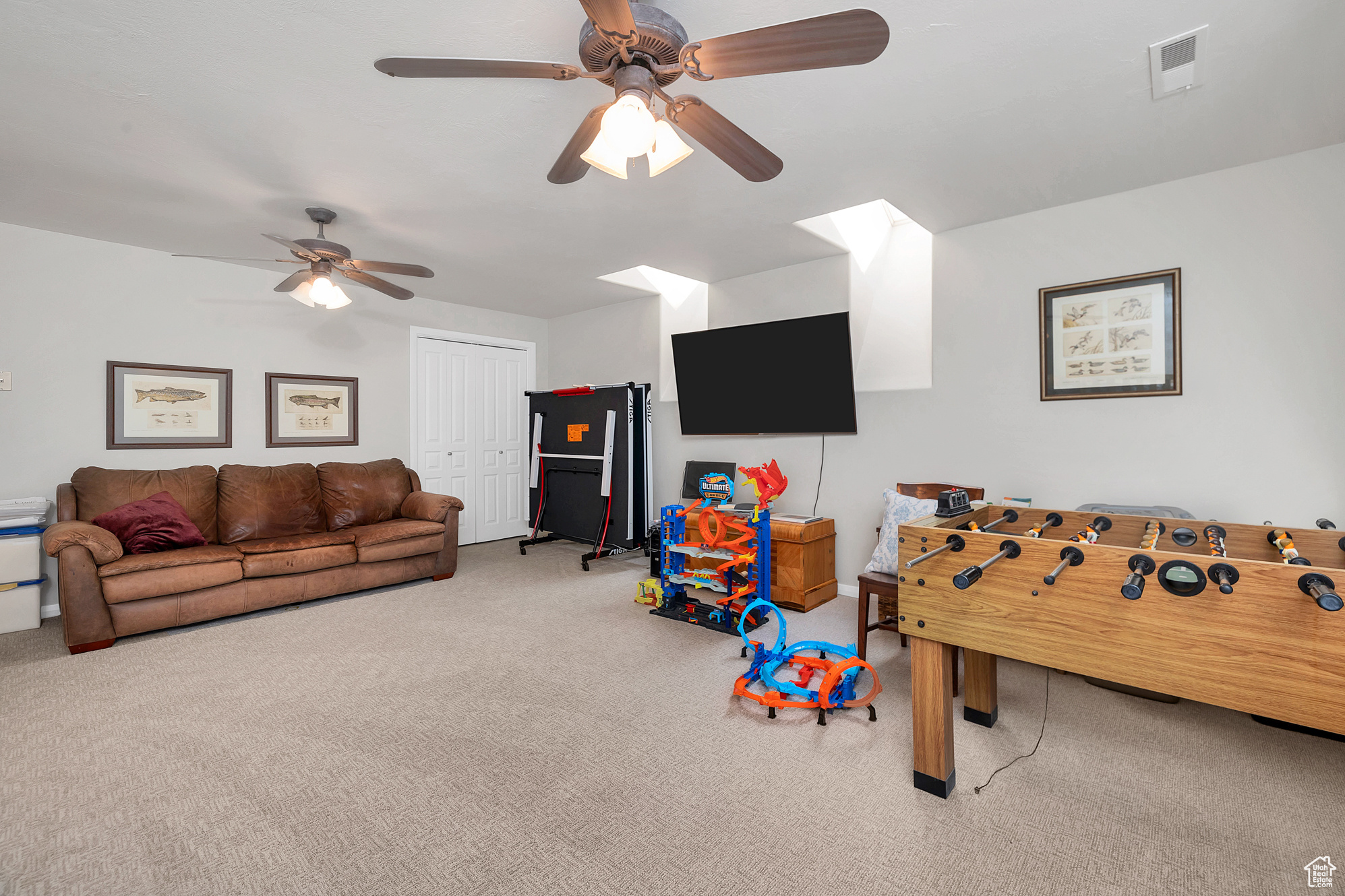 Rec room featuring visible vents, ceiling fan, and carpet flooring