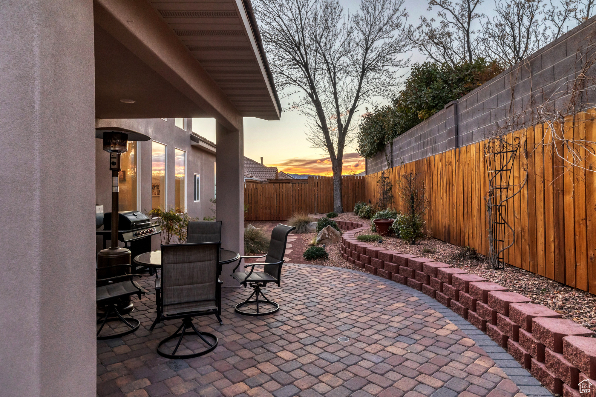 View of patio featuring outdoor dining space, a grill, and a fenced backyard