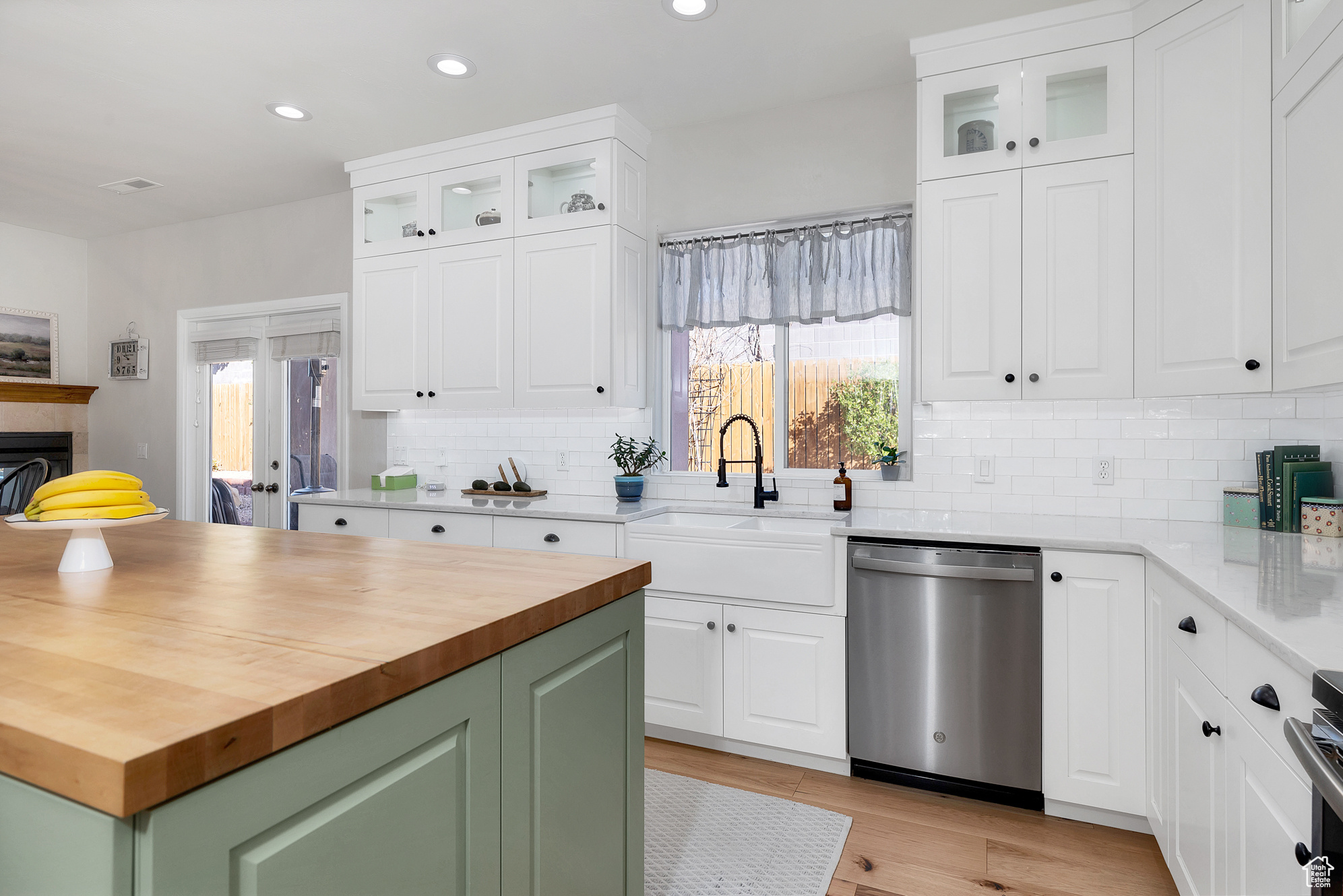 Kitchen featuring a sink, a healthy amount of sunlight, wood counters, and stainless steel dishwasher