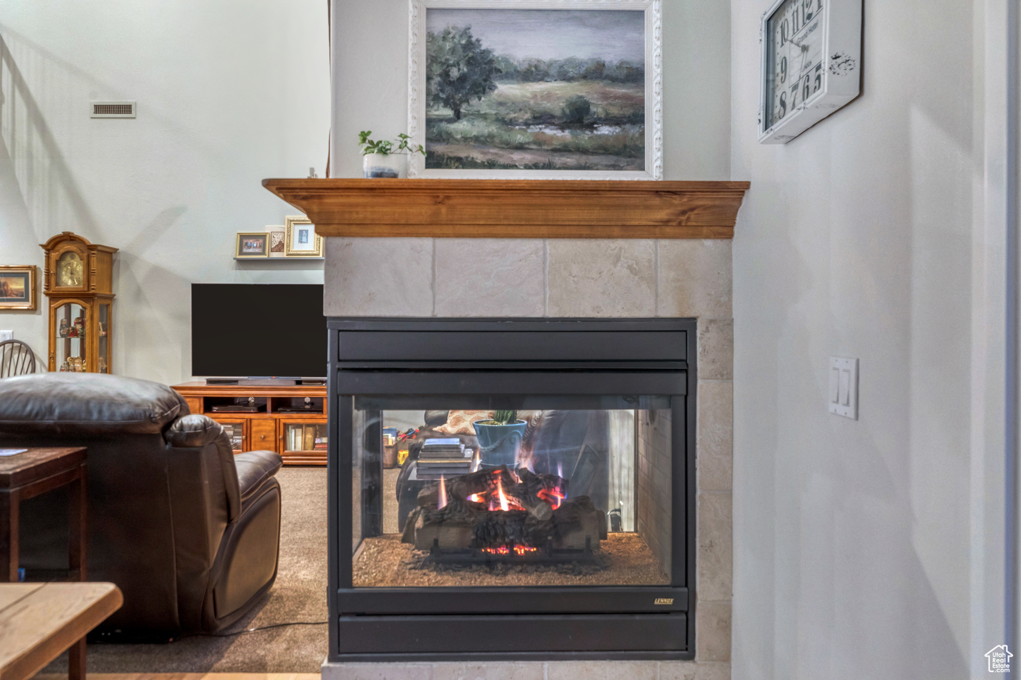 Room details featuring visible vents and a multi sided fireplace