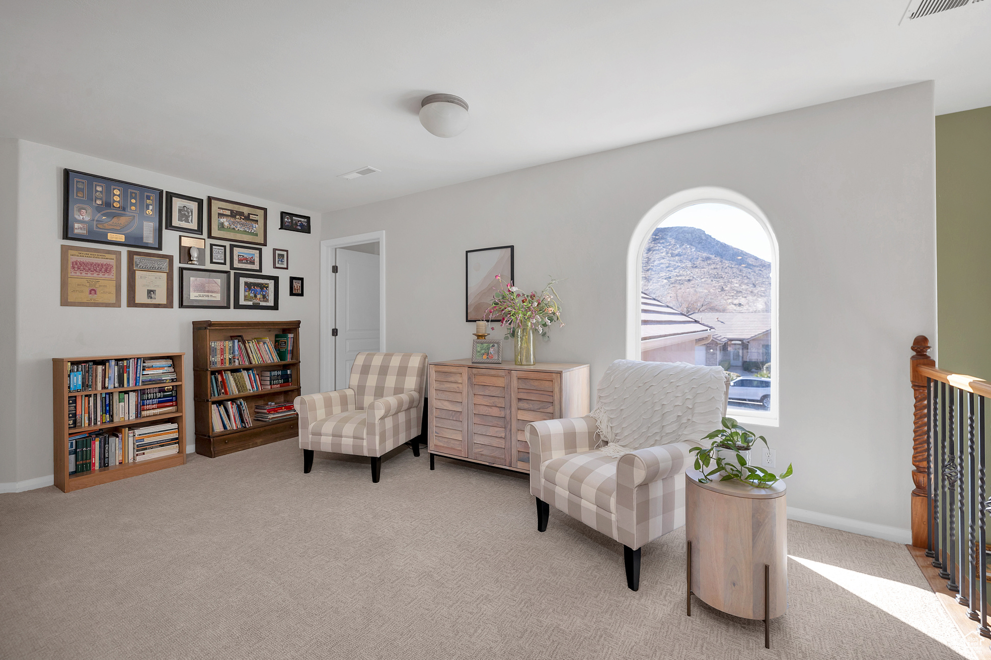 Sitting room featuring baseboards and light colored carpet