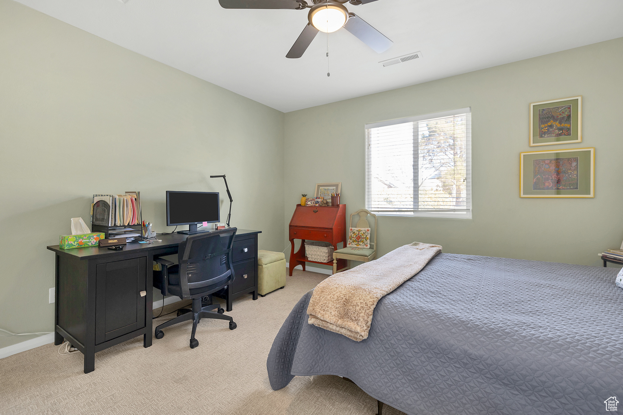 Bedroom with visible vents, light colored carpet, and a ceiling fan