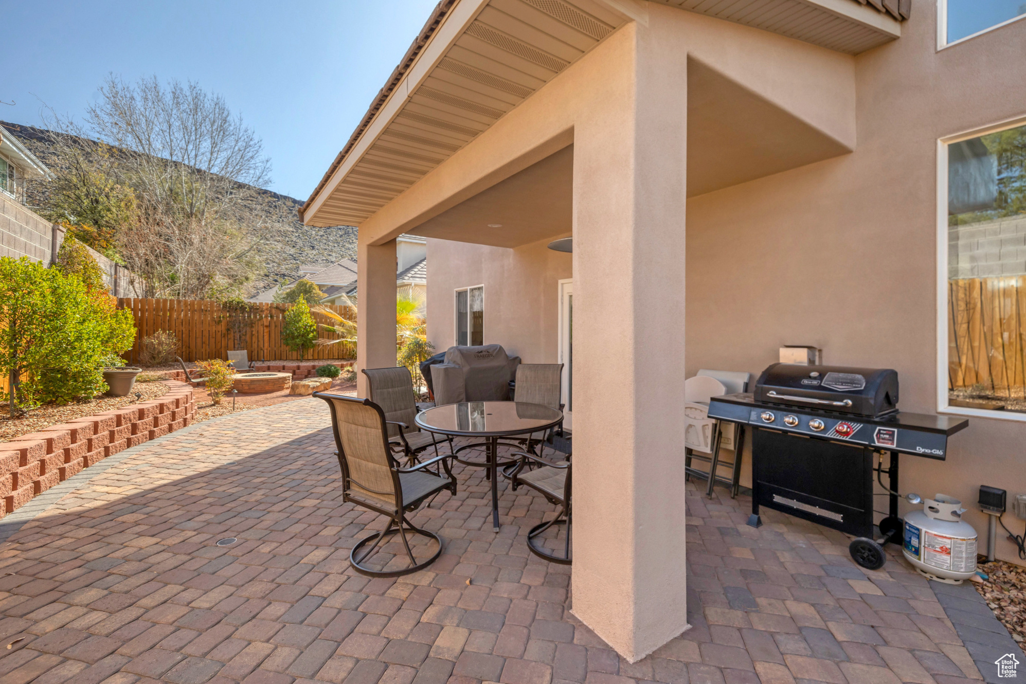 View of patio featuring outdoor dining space, area for grilling, and fence