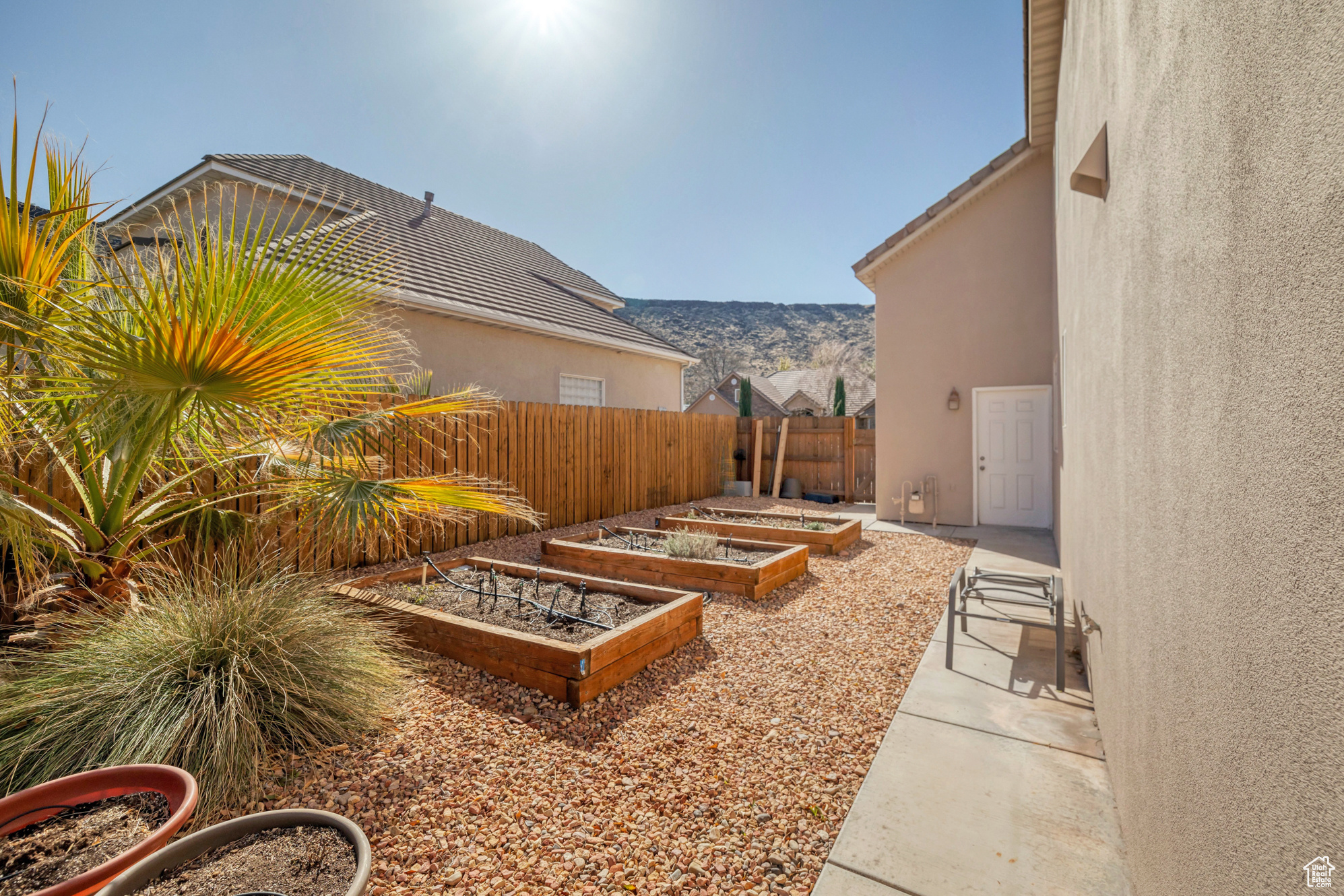 View of yard with a vegetable garden and fence