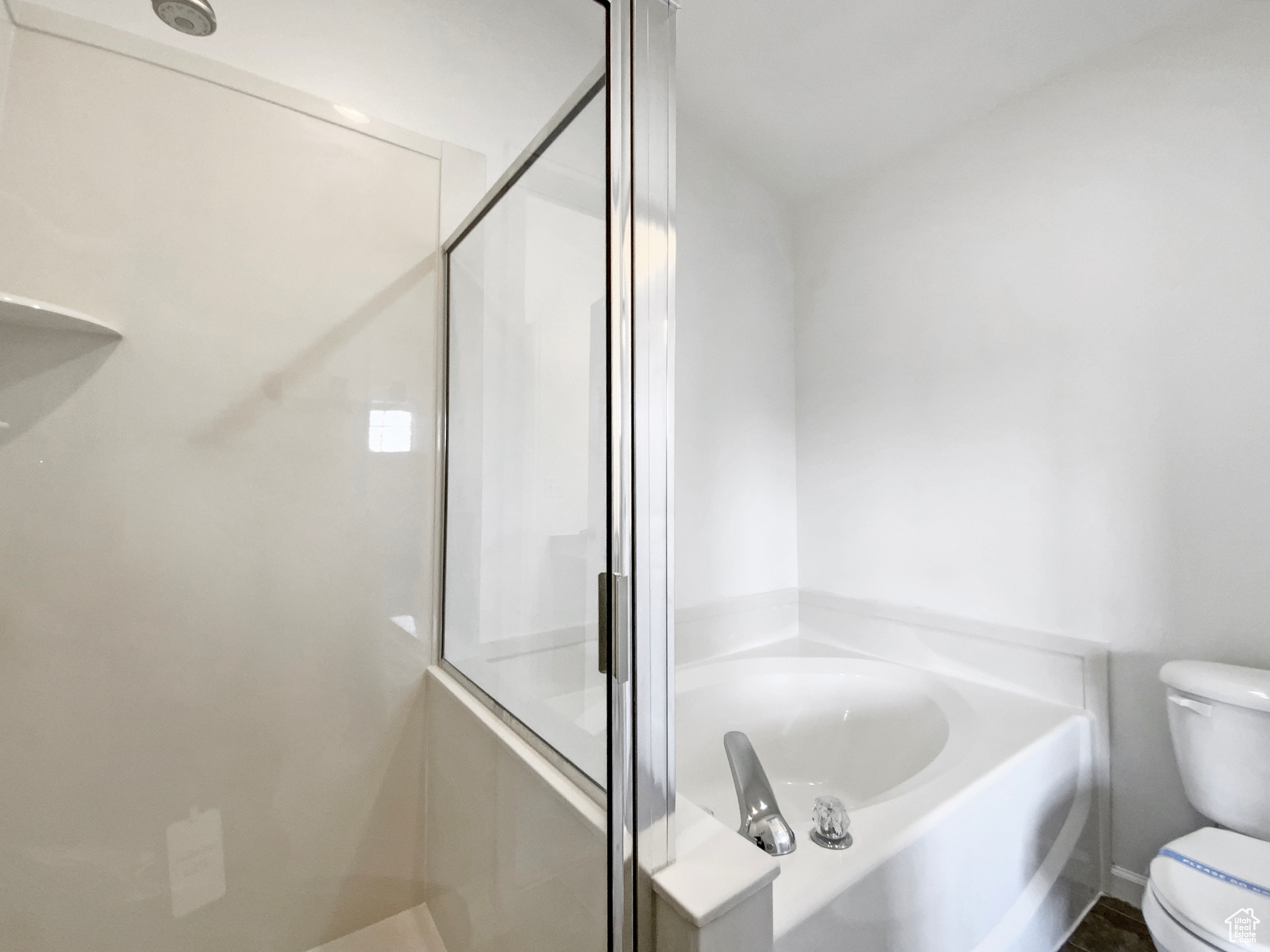 Full bath featuring a bath, a shower stall, and toilet
