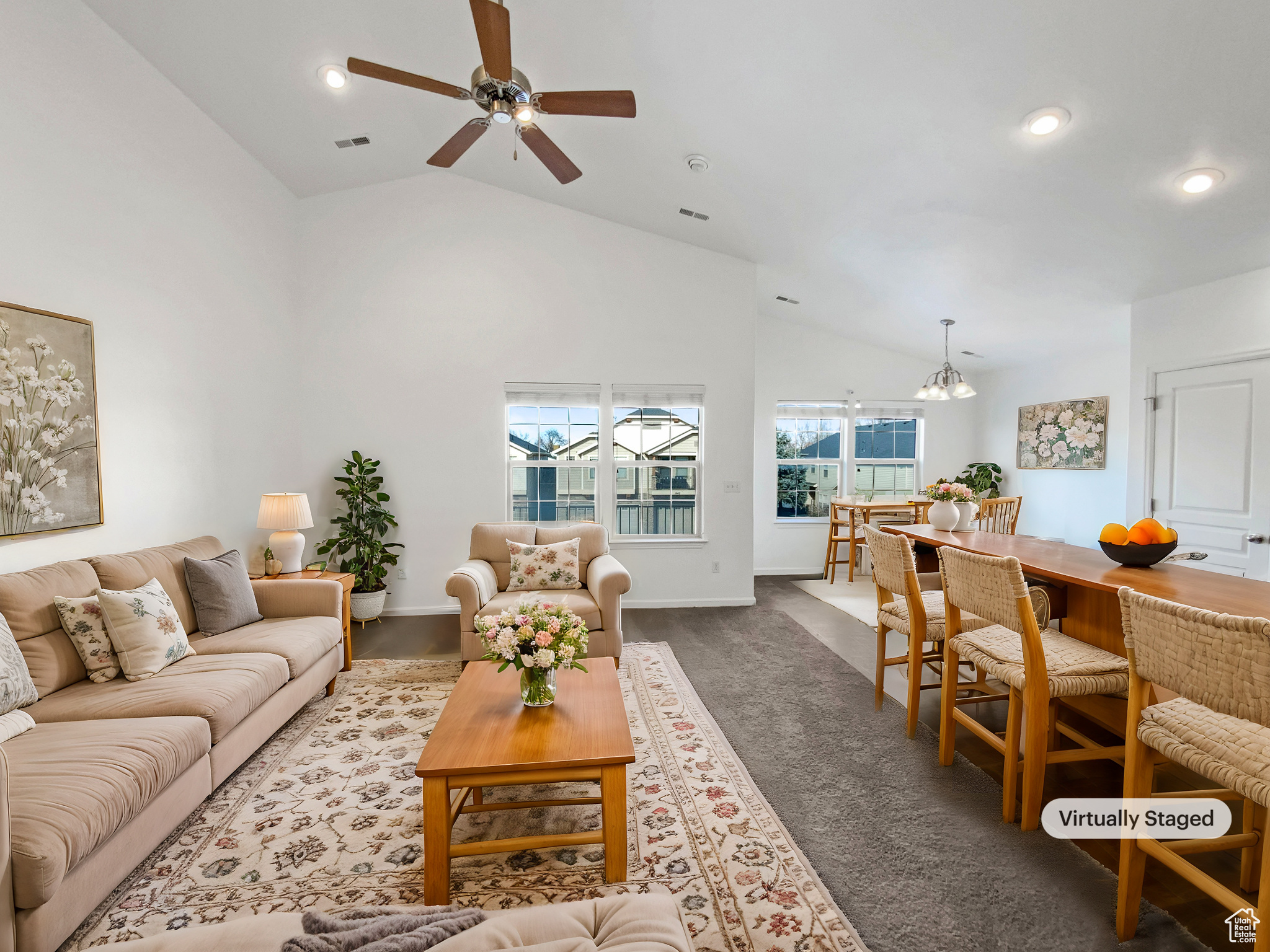 Living area with recessed lighting, baseboards, visible vents, and high vaulted ceiling