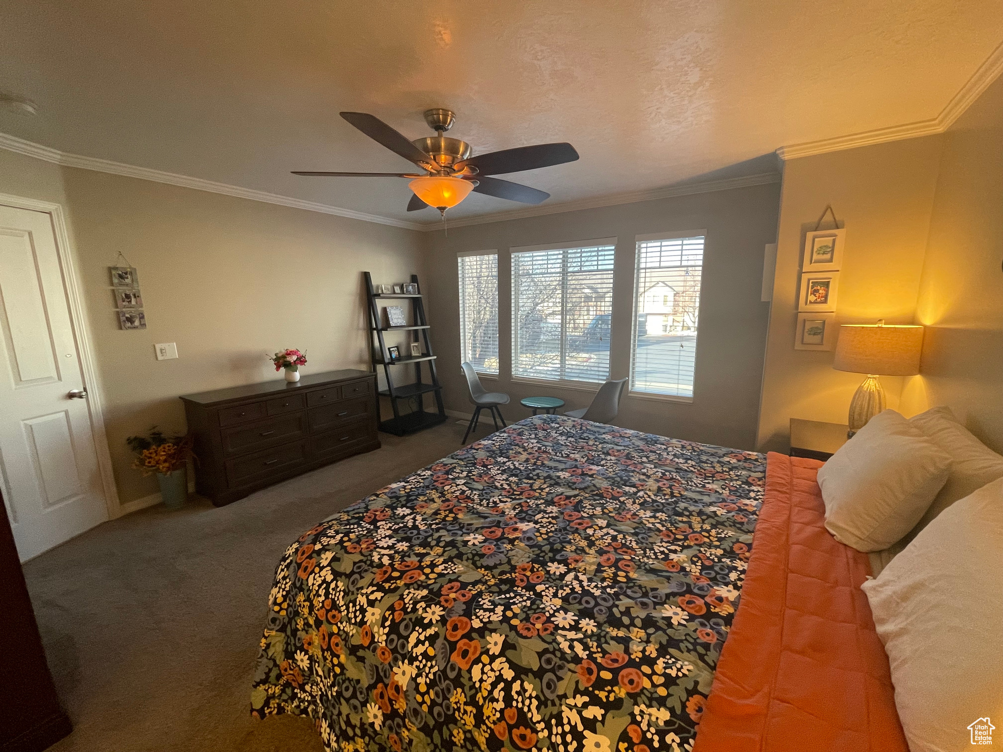 Primary Bedroom with a ceiling fan, carpet floors, and ornamental molding