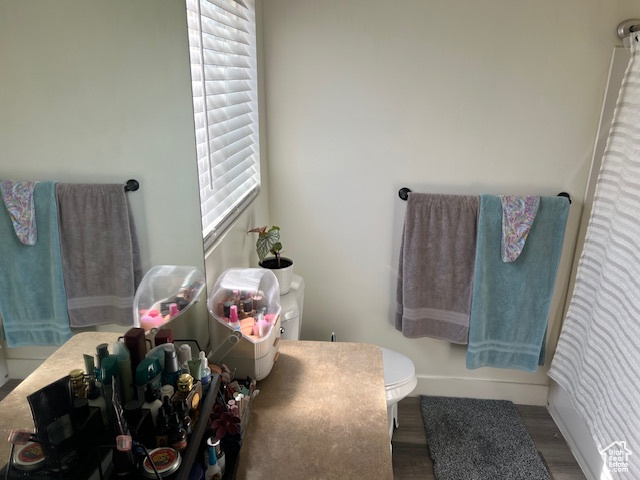 Bathroom with toilet and wood finished floors