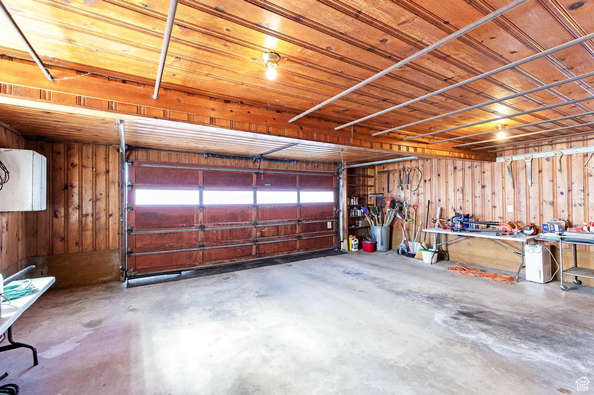 Garage with wood walls and wooden ceiling