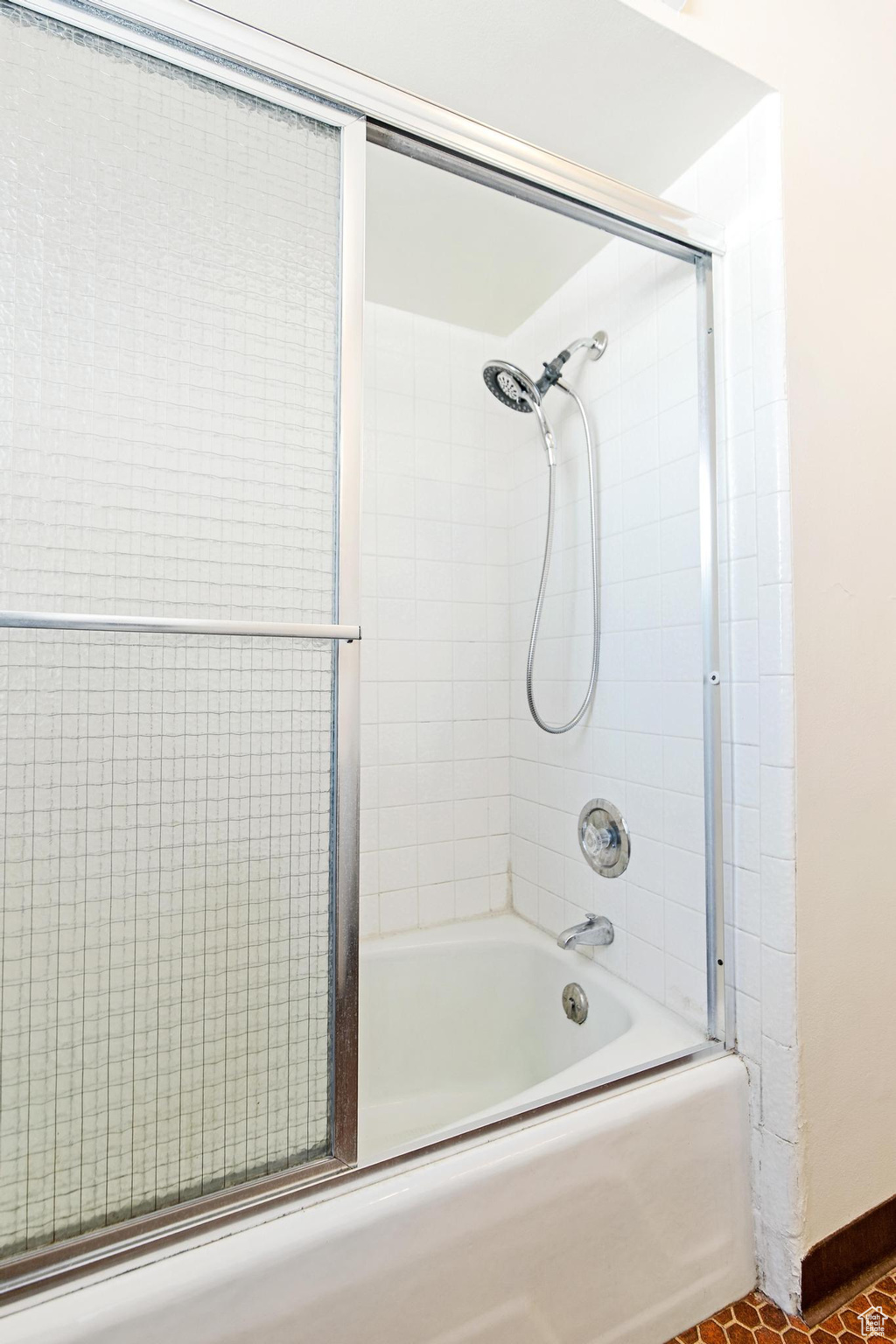 Full bathroom featuring combined bath / shower with glass door