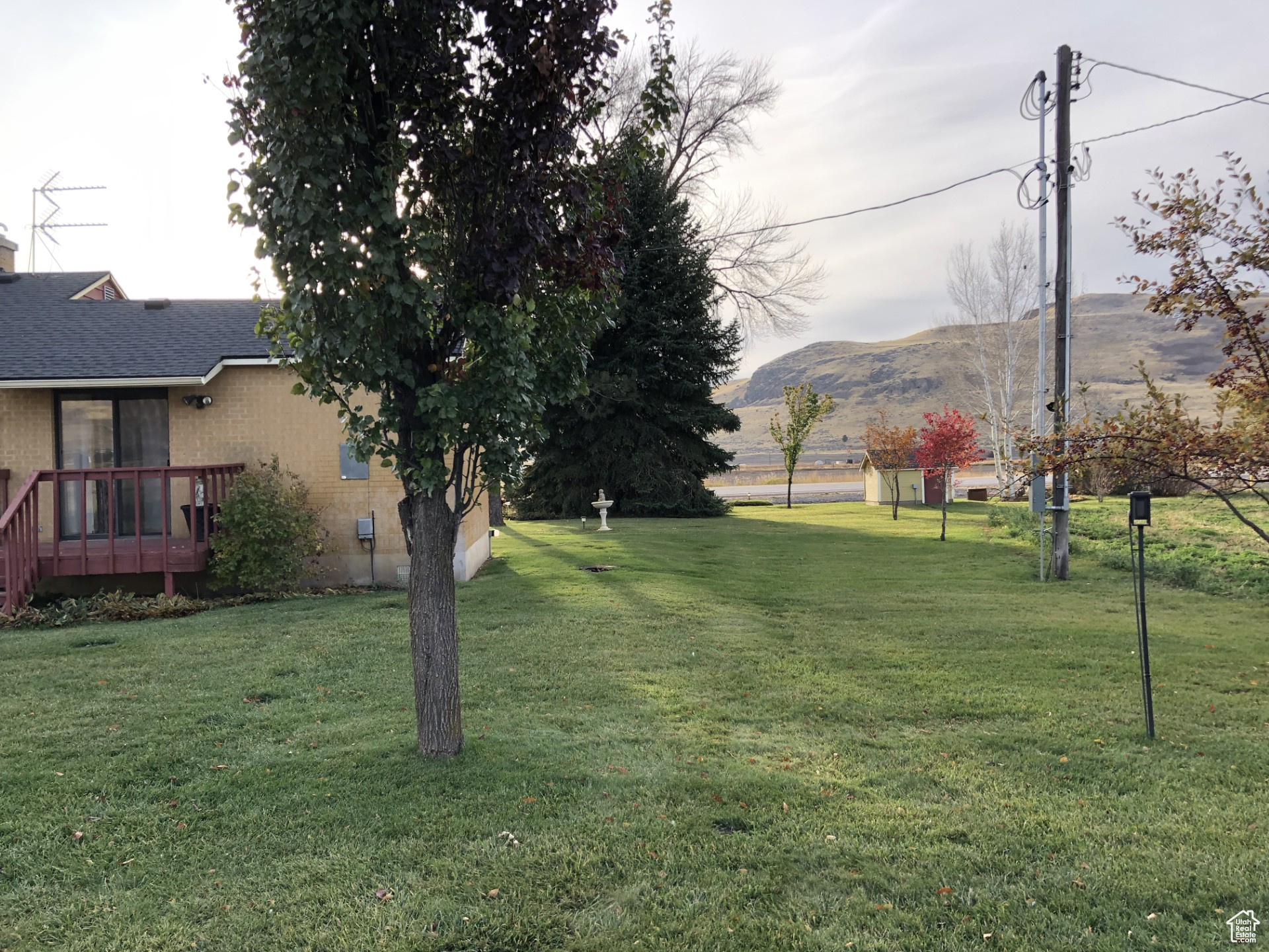View of yard featuring a deck with mountain view