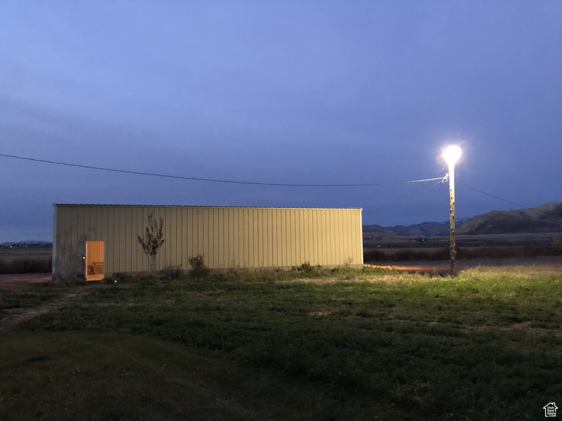 View of yard featuring an outbuilding, a mountain view, and an outdoor structure