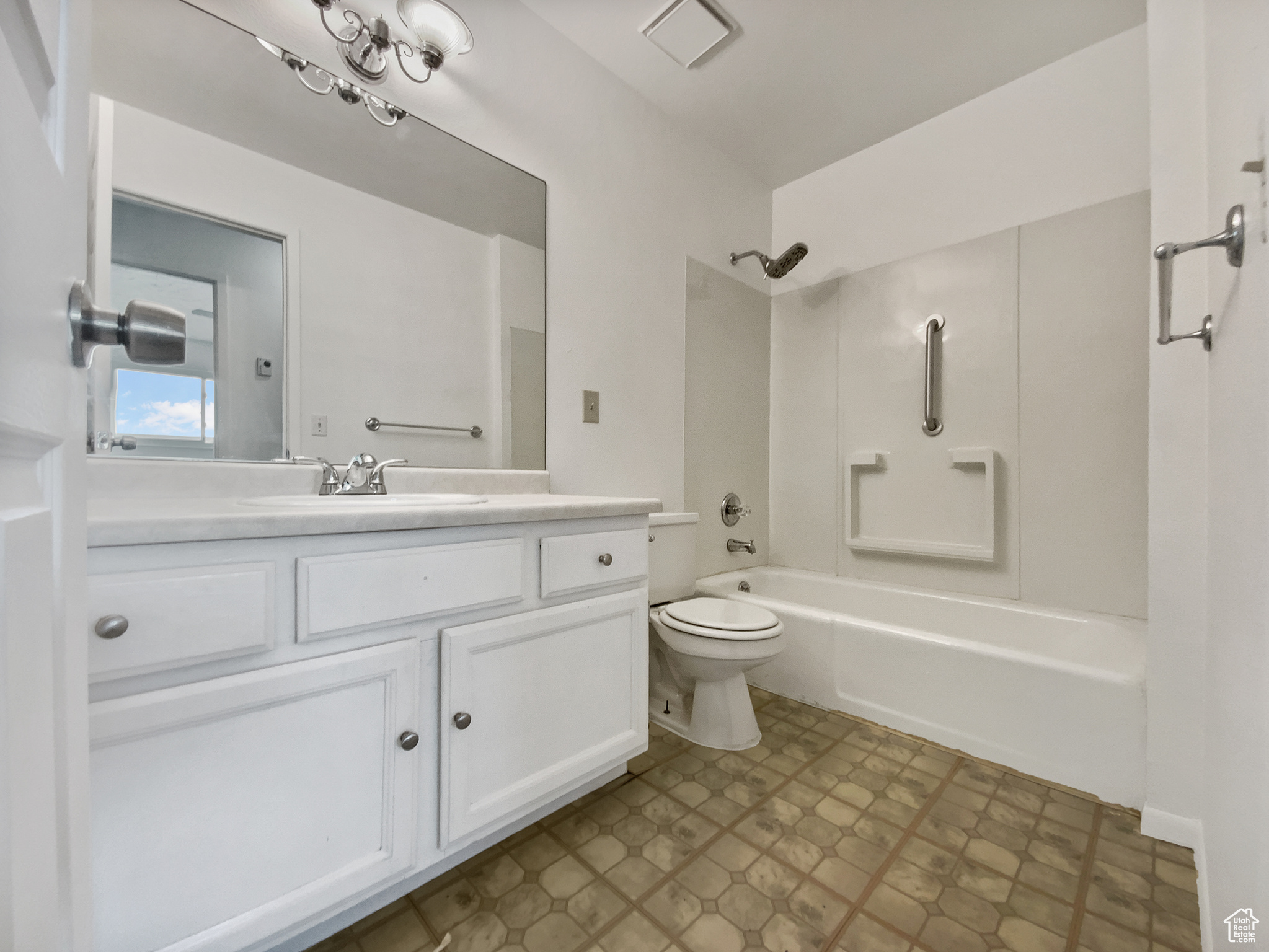 Full bathroom featuring vanity, toilet, and shower / bathtub combination