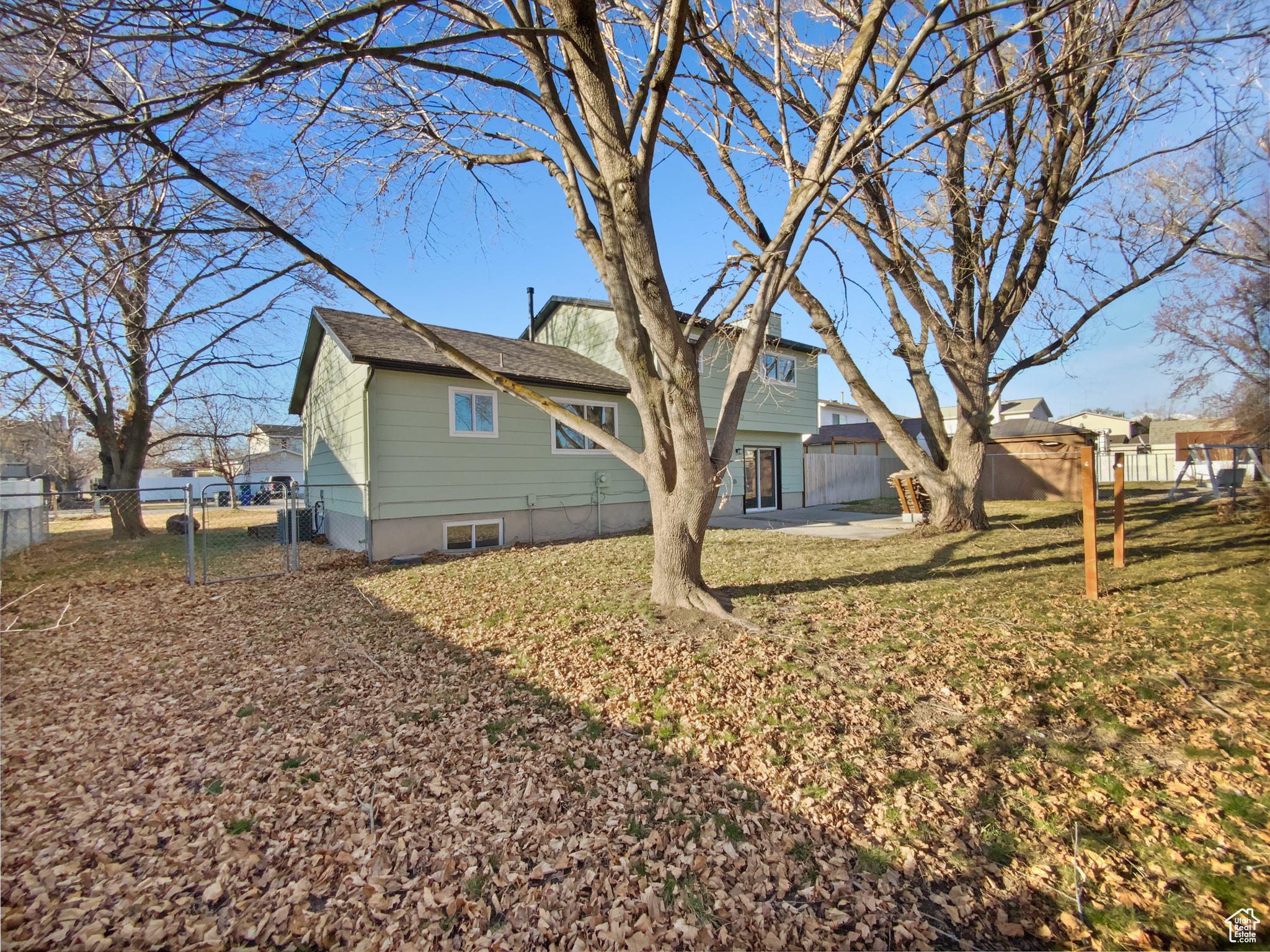 Rear view of property with fence, a yard, and a gate
