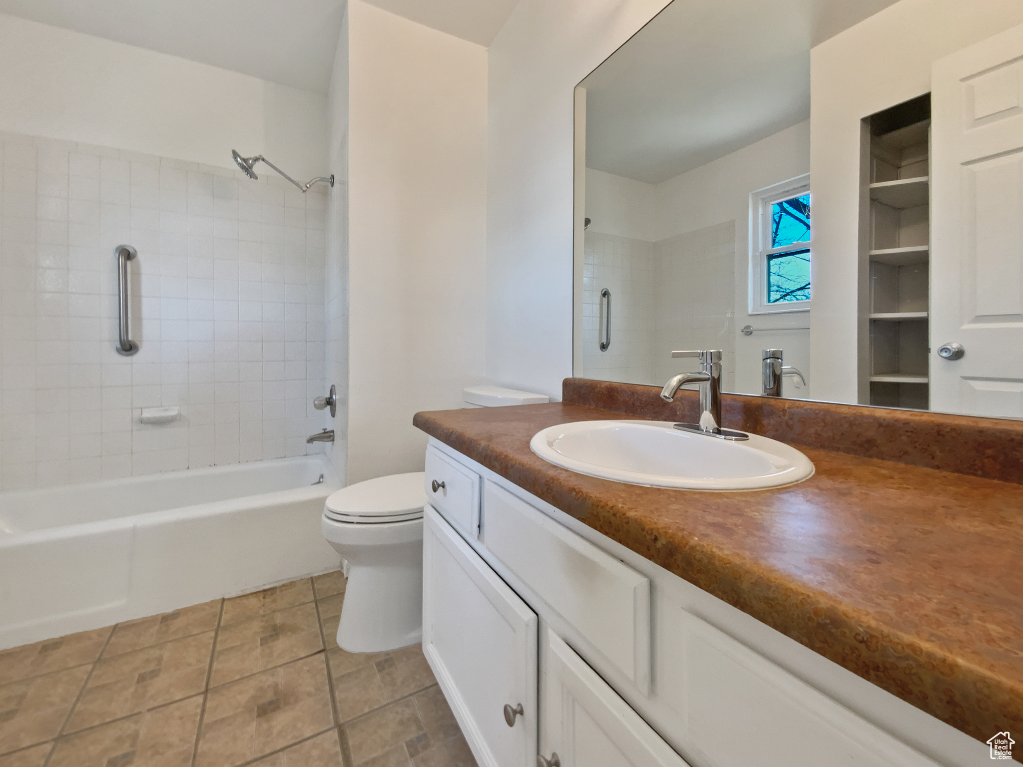 Full bathroom with vanity, toilet, tile patterned flooring, and shower / bath combination