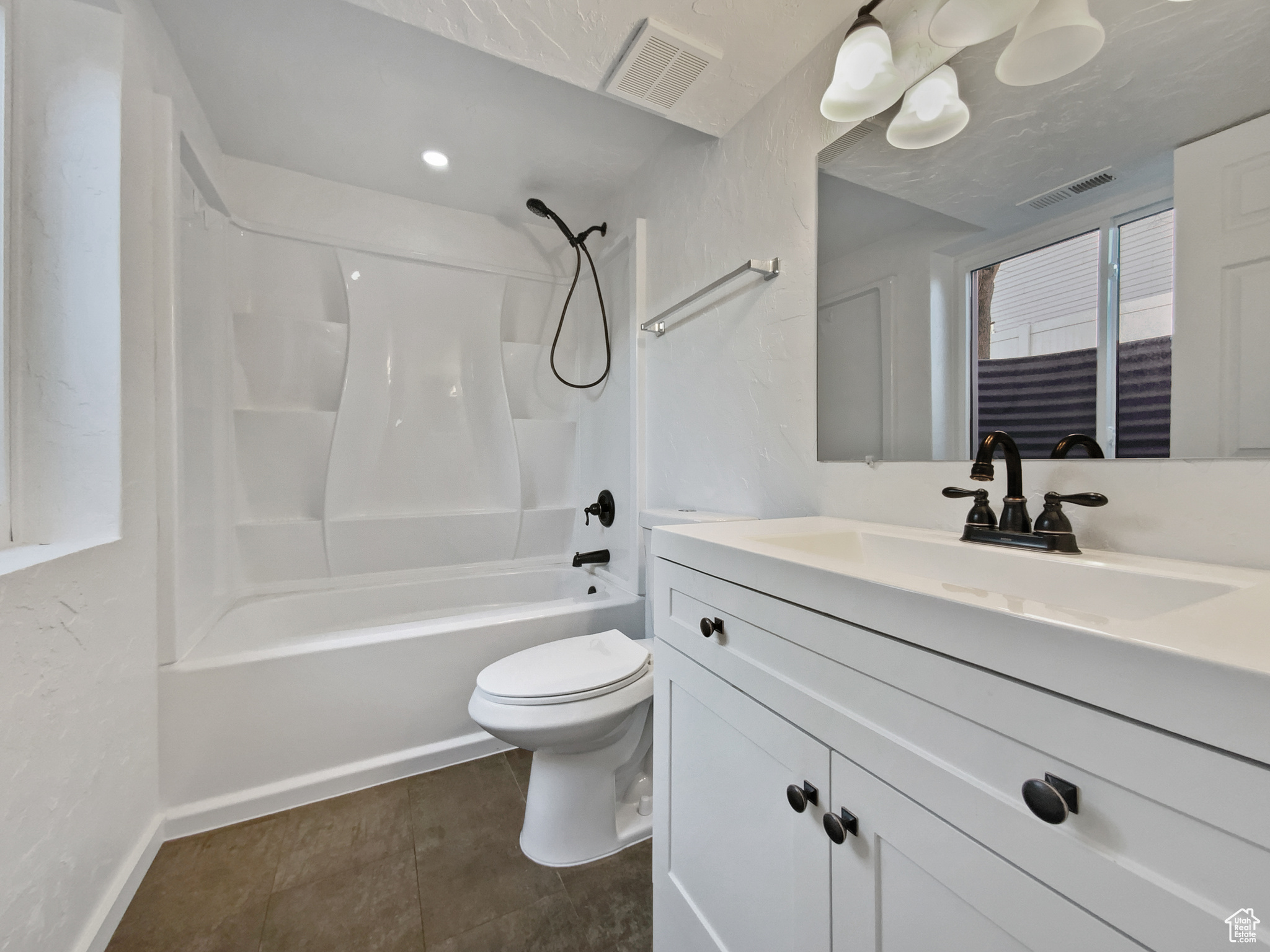 Full bath featuring vanity, toilet, visible vents, and shower / washtub combination