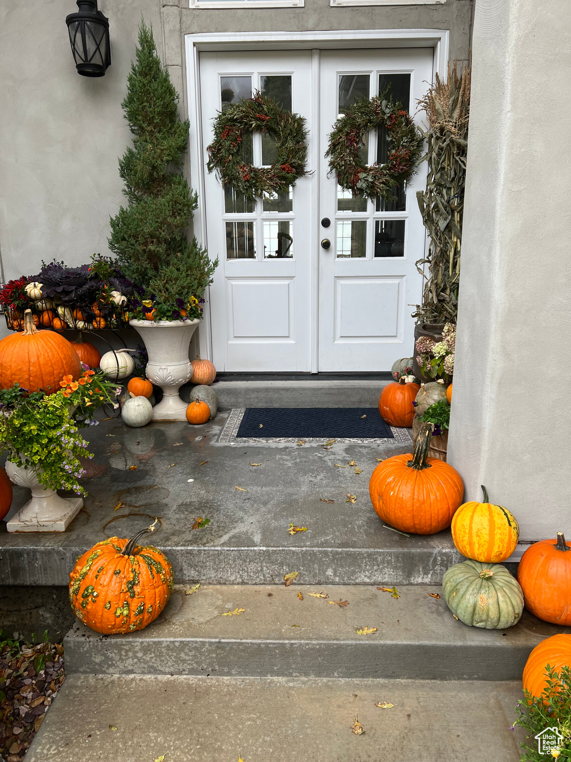 View of exterior entry with stucco siding and french doors