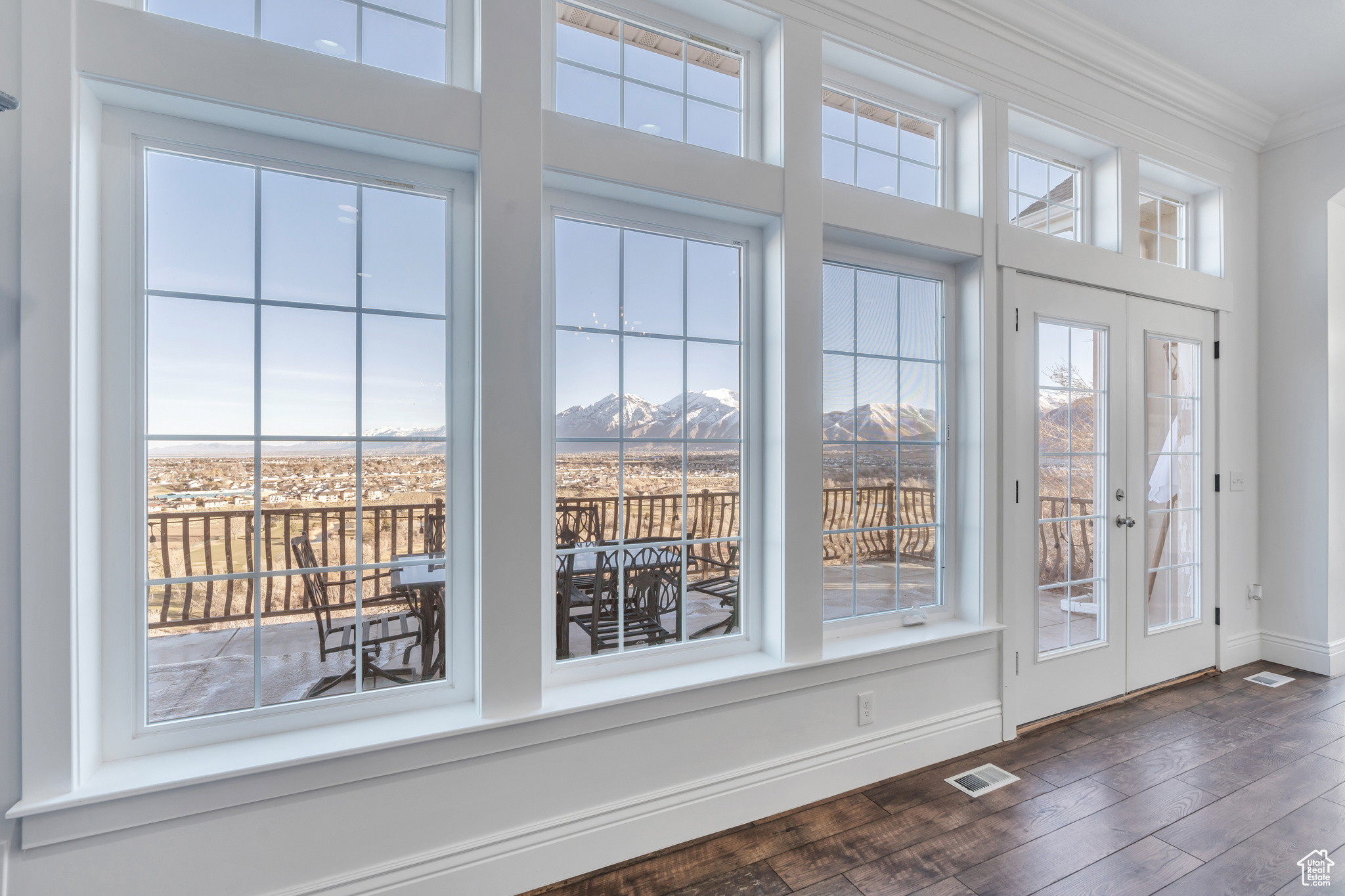 Doorway featuring visible vents, crown molding, baseboards, a mountain view, and dark wood-style flooring