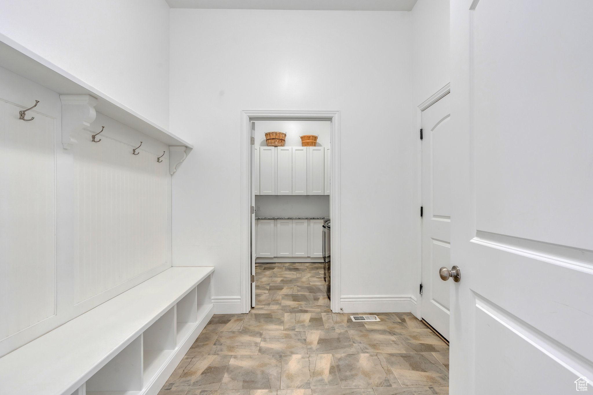 Mudroom with visible vents, stone finish flooring, and baseboards