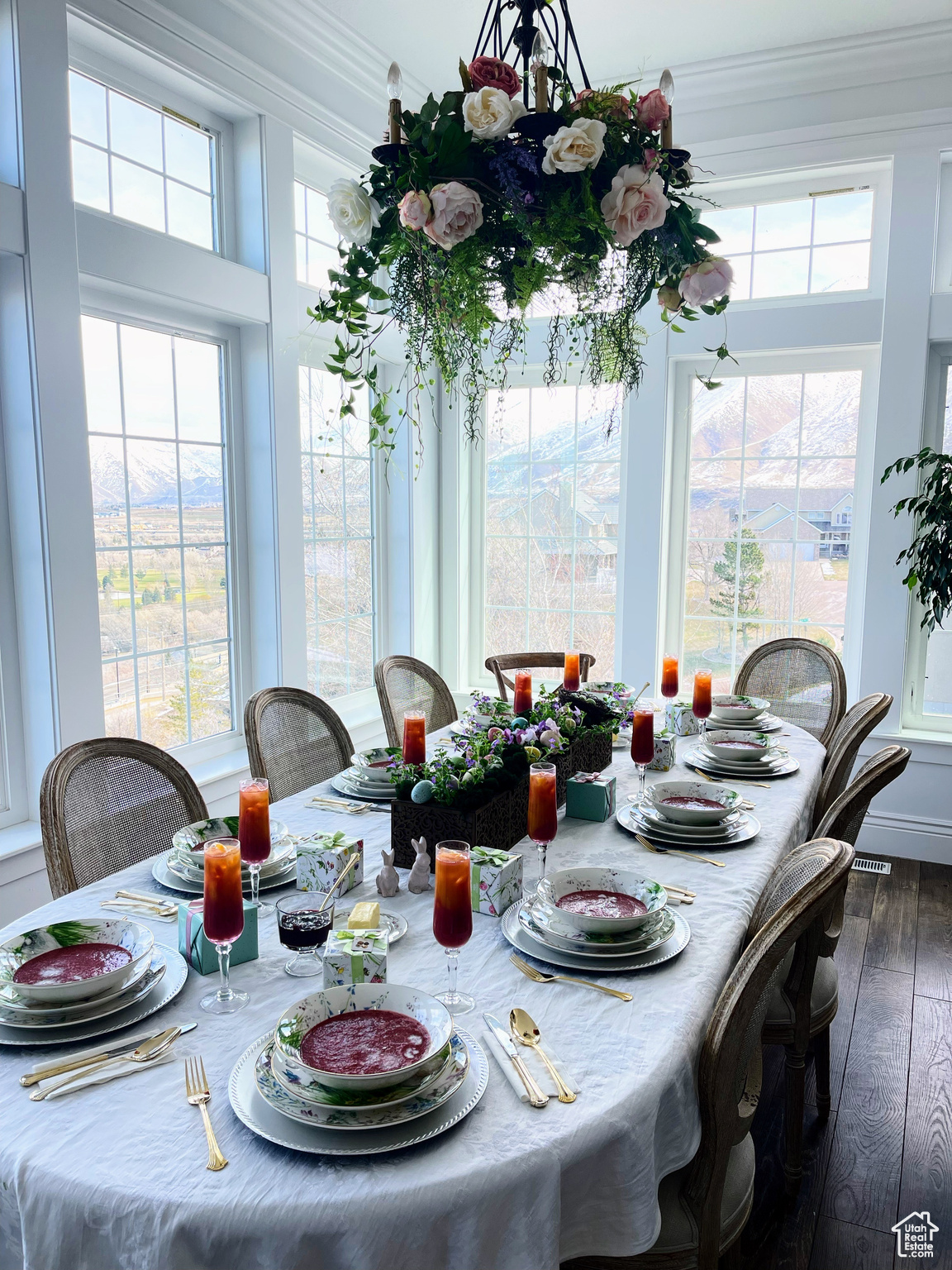 Dining space with wood-type flooring and ornamental molding