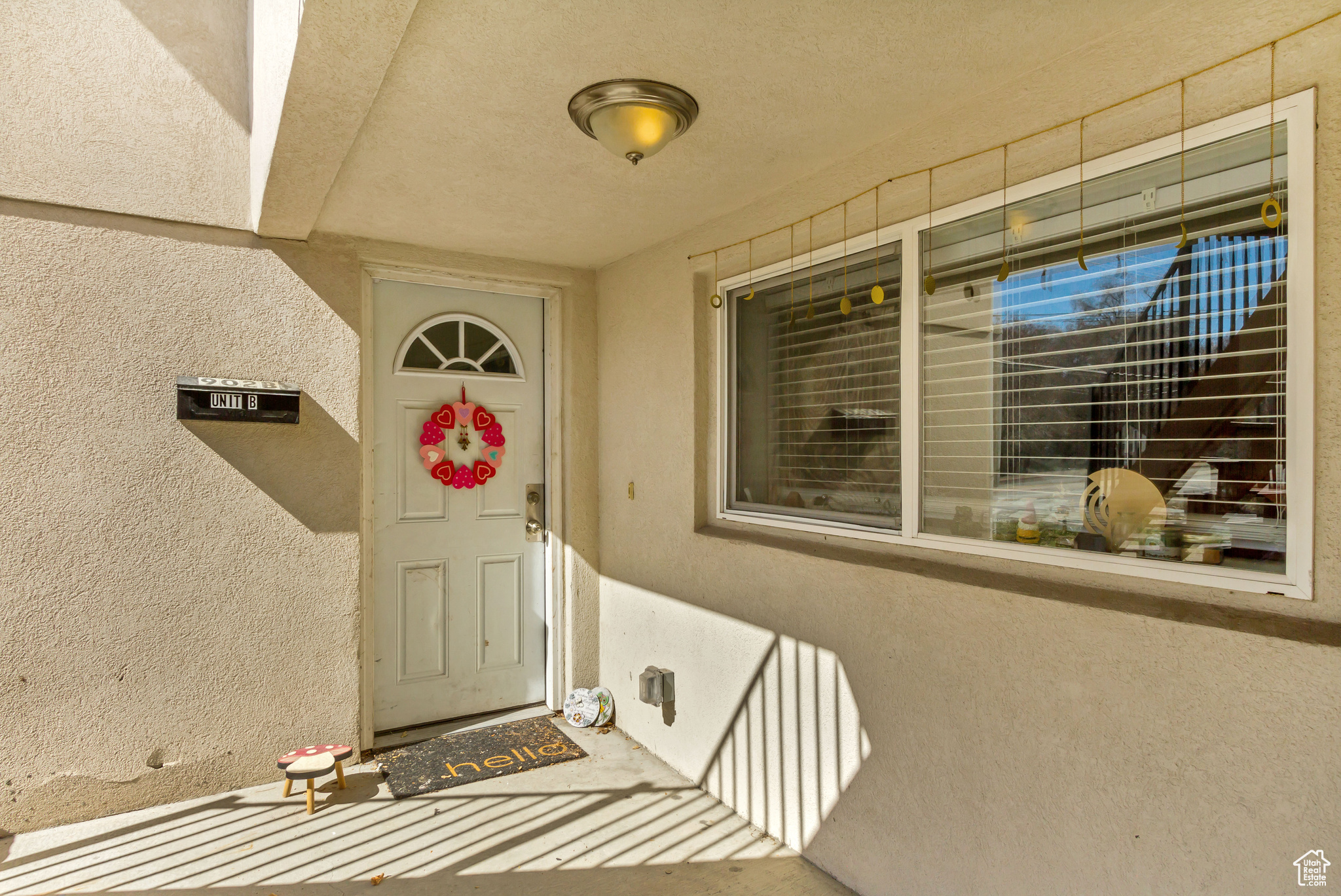 Entrance to property with stucco siding