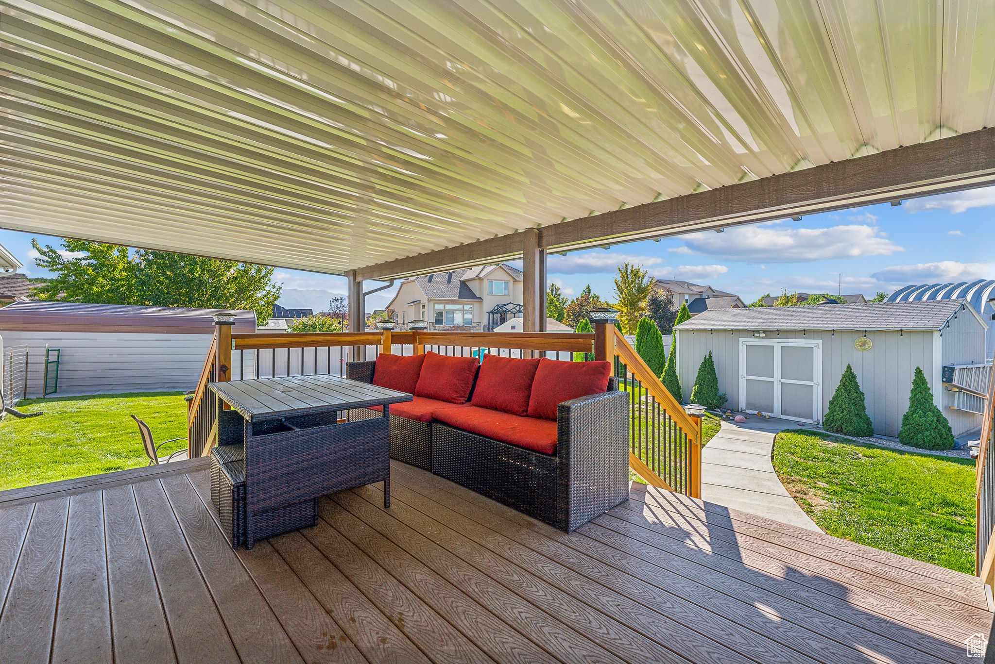 Deck featuring a storage shed, an outbuilding, a yard, and an outdoor living space