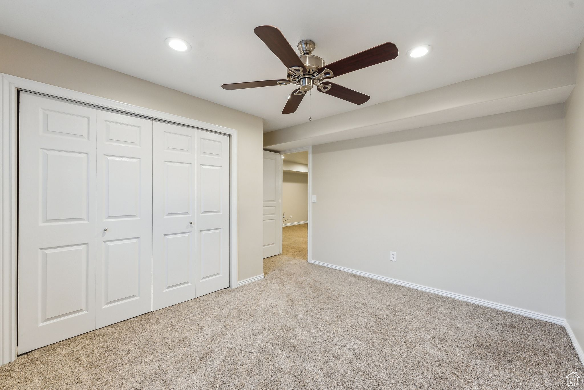Unfurnished bedroom featuring a closet, recessed lighting, baseboards, and carpet floors