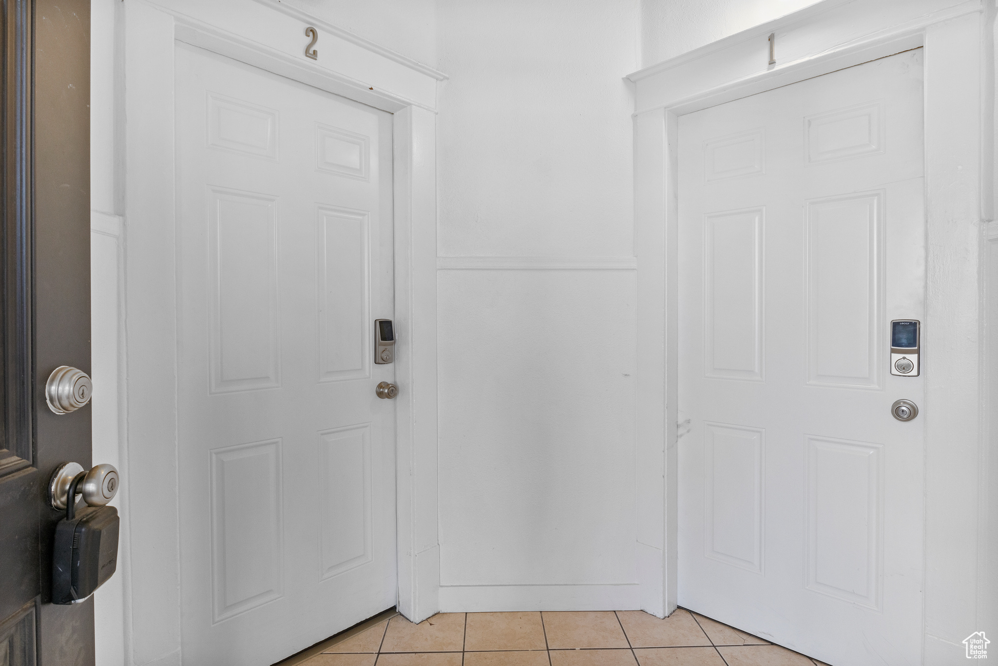 Foyer entrance featuring light tile patterned floors