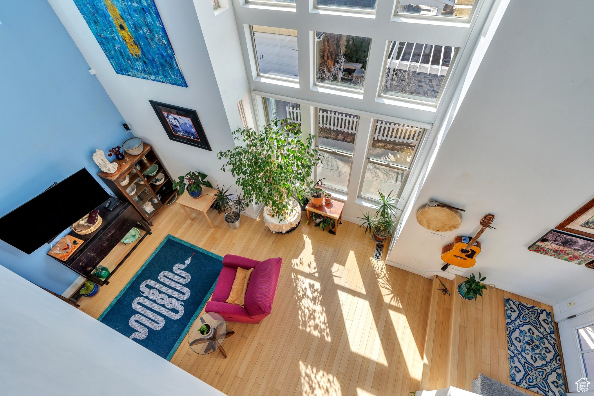 Living room featuring plenty of natural light and a towering ceiling