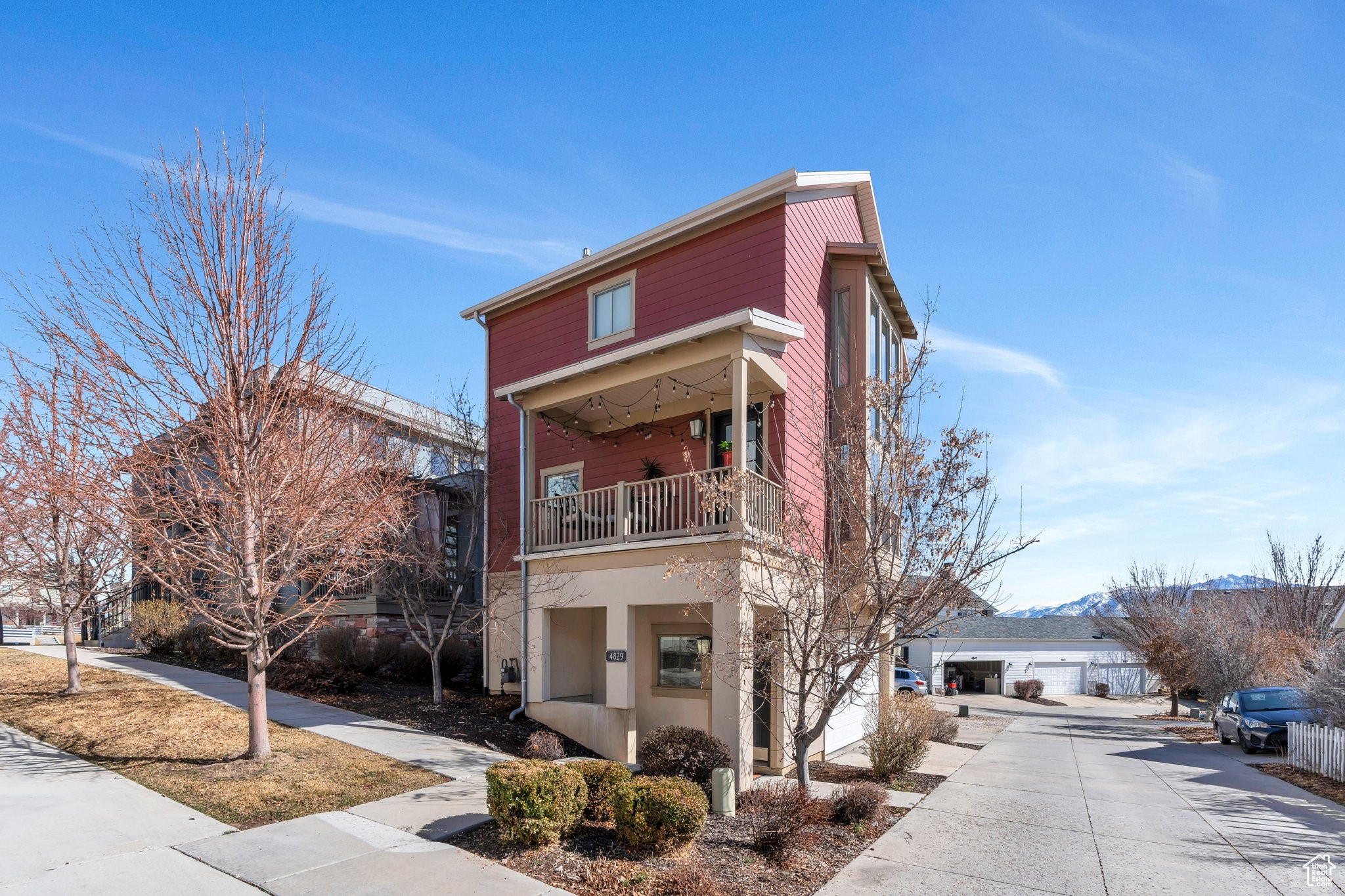 View of building exterior featuring a garage and a mountain view
