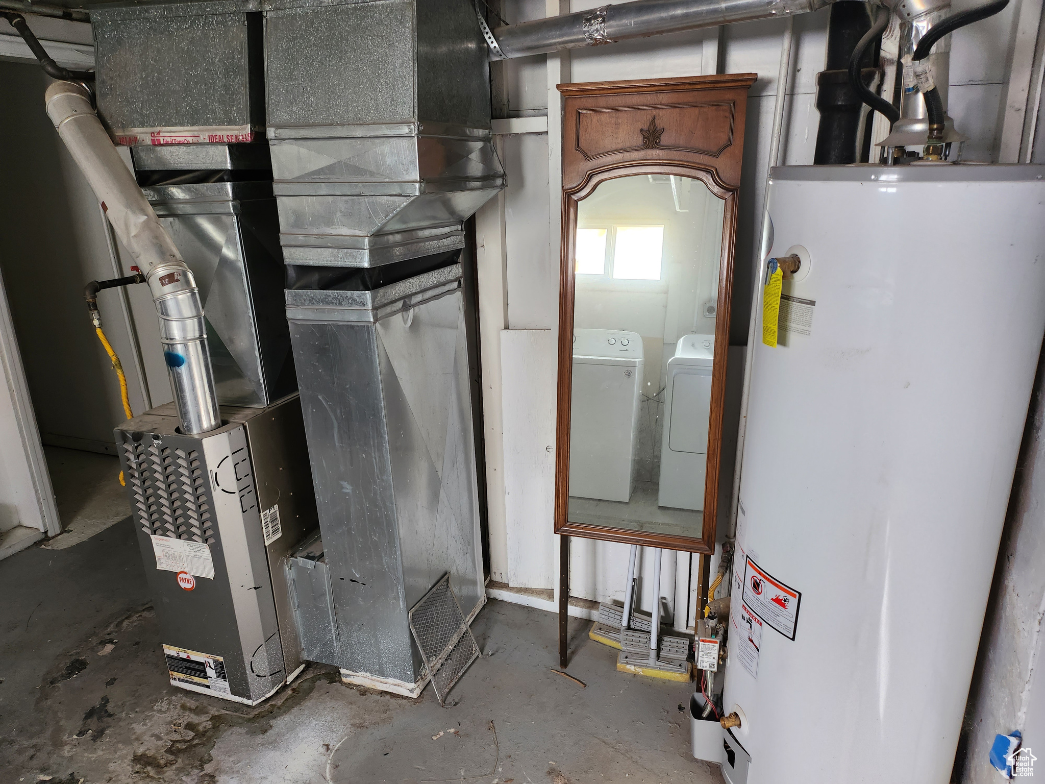 Utilities featuring washing machine and clothes dryer and gas water heater