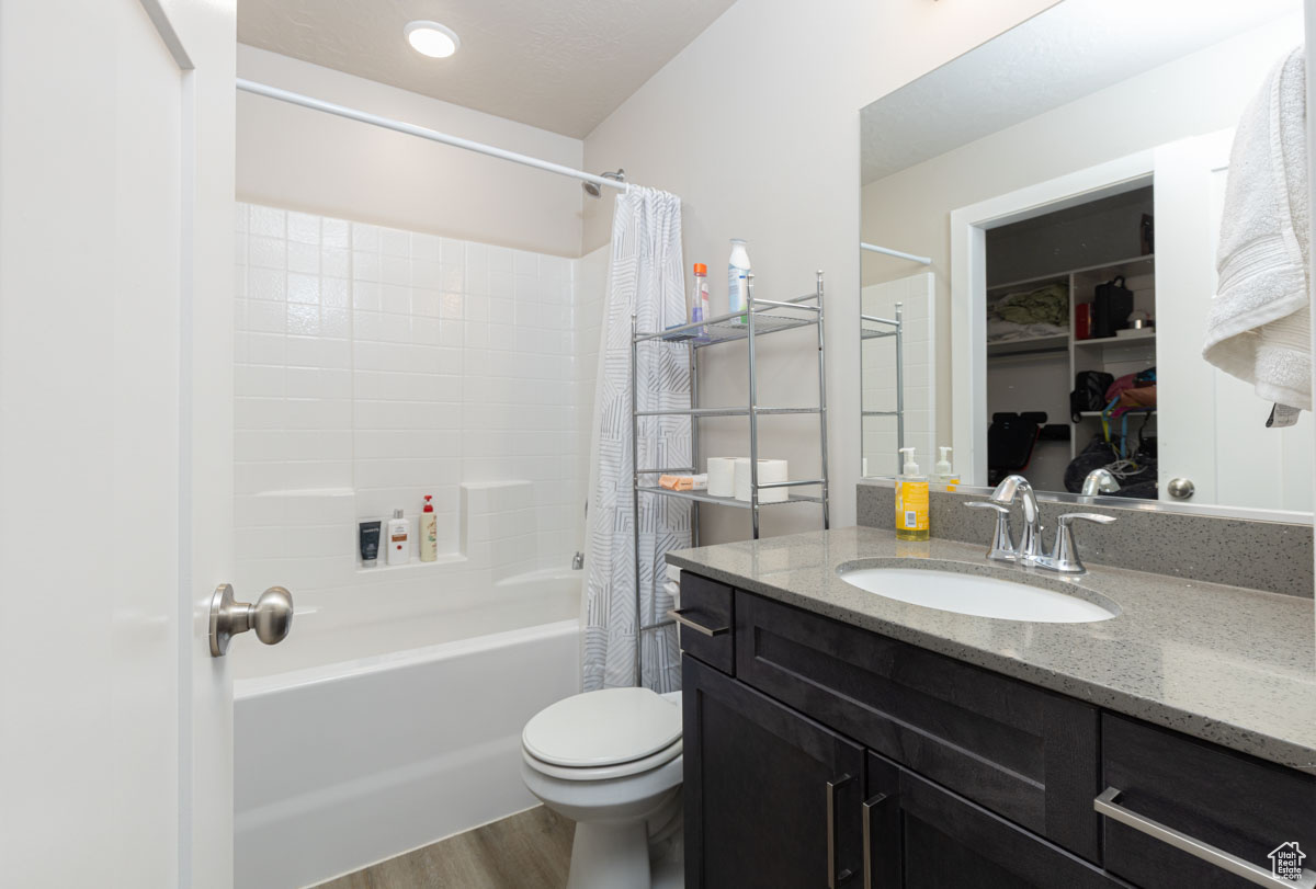 Bathroom with shower / tub combo with curtain, toilet,  and vanity