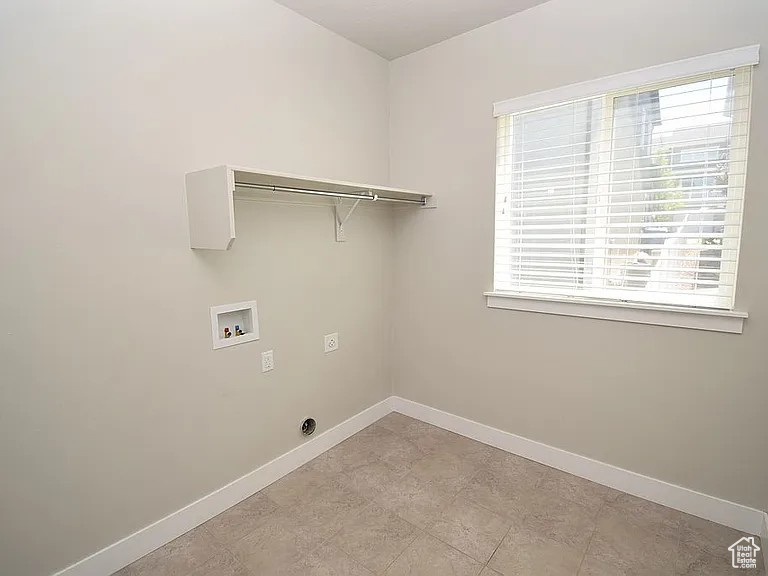 Laundry room with laundry area, electric dryer hookup, baseboards, and washer hookup