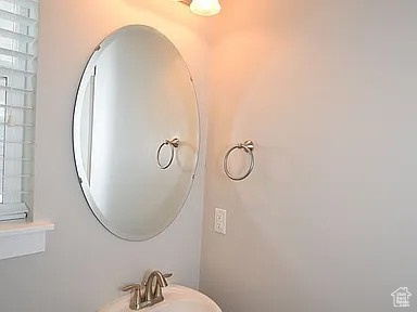 Bathroom with a healthy amount of sunlight and a sink