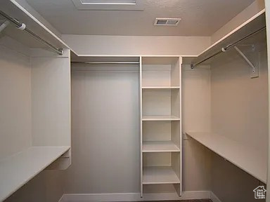 Spacious closet featuring visible vents