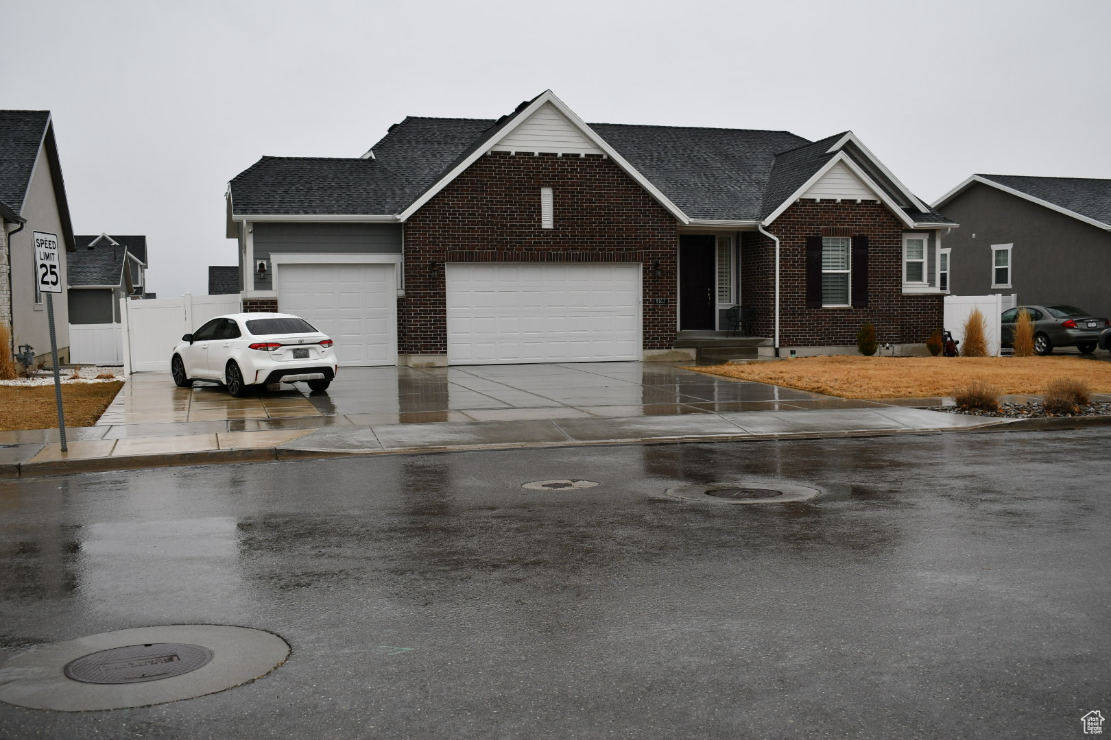 Ranch-style house with an attached garage, brick siding, a shingled roof, fence, and driveway