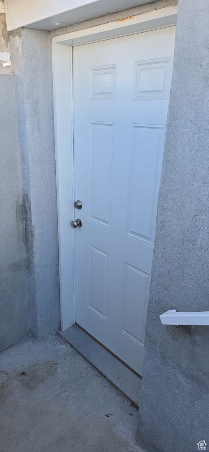 Property entrance featuring stucco siding