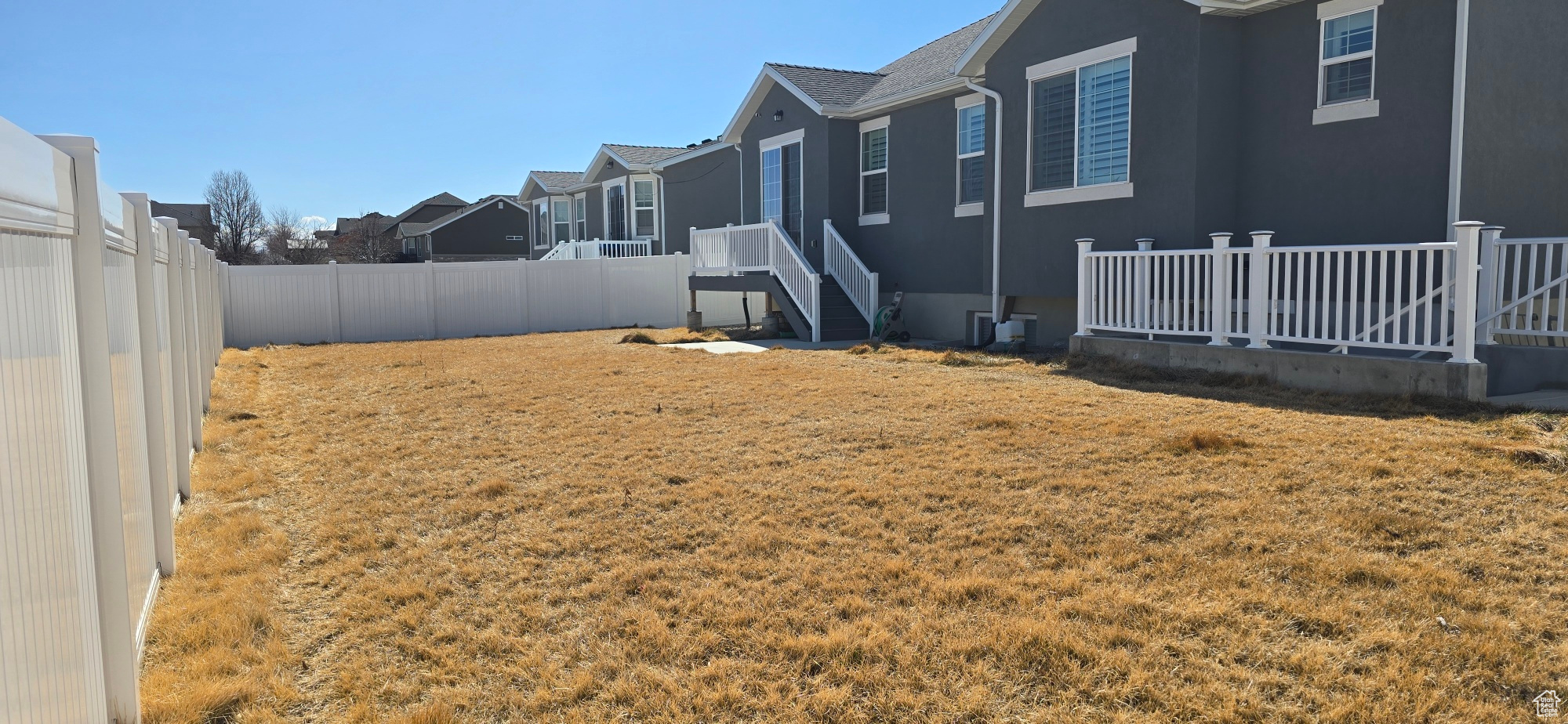 View of yard featuring a residential view and fence