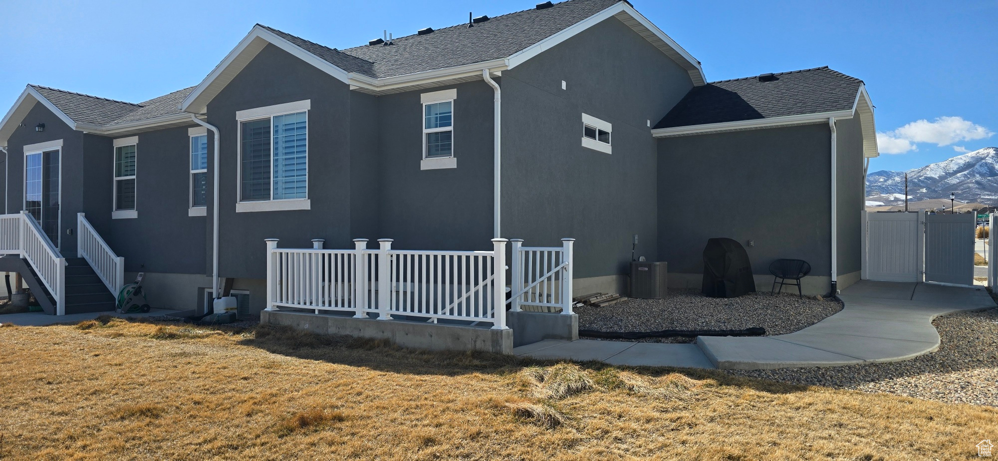 Back of house featuring a yard and stucco siding
