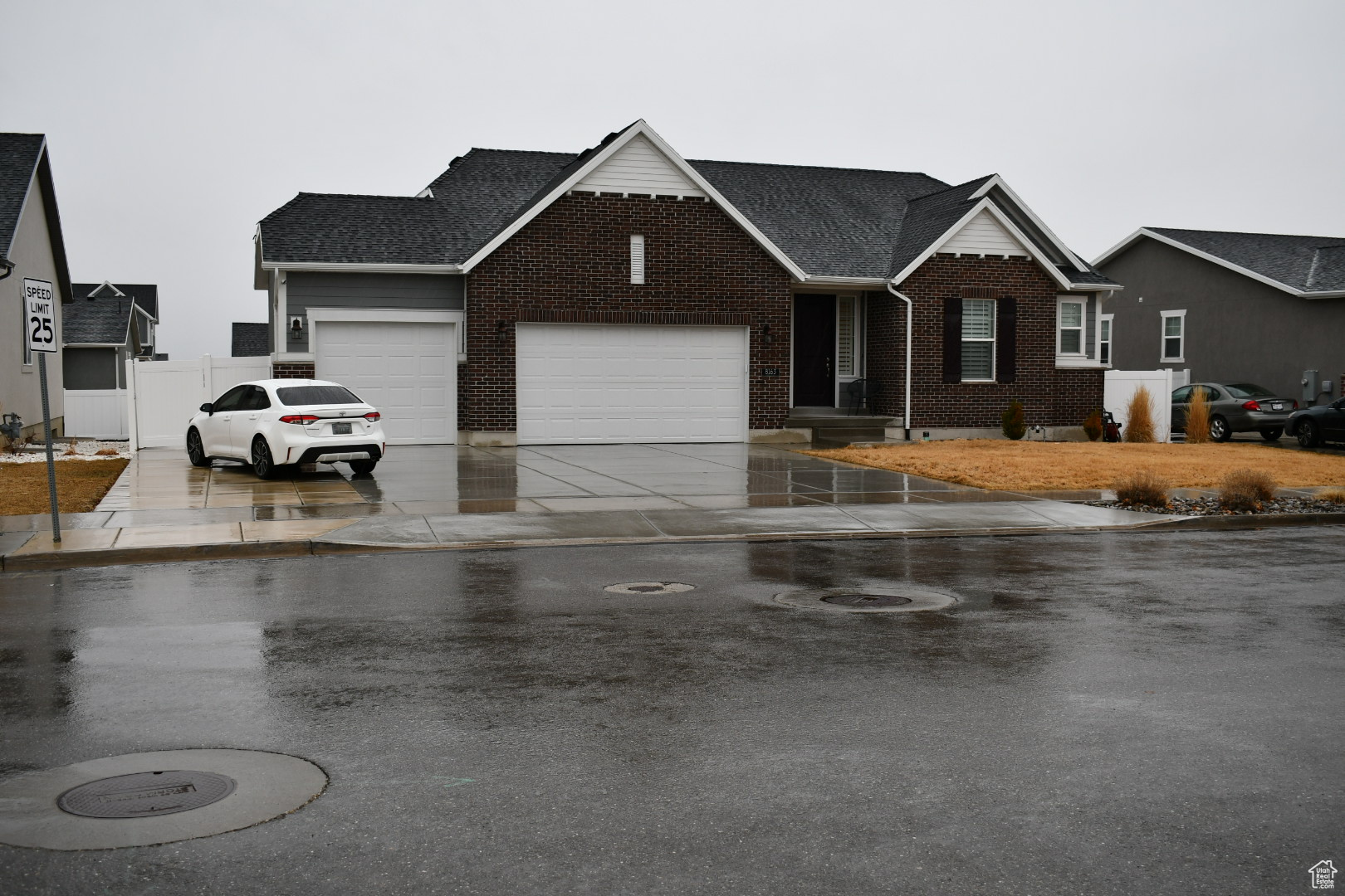 Single story home featuring concrete driveway, brick siding, and an attached garage