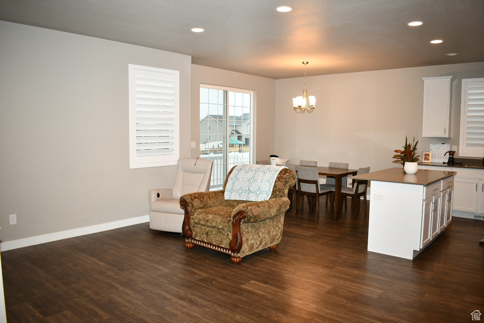 Sitting room featuring baseboards, recessed lighting, dark wood finished floors, and a notable chandelier