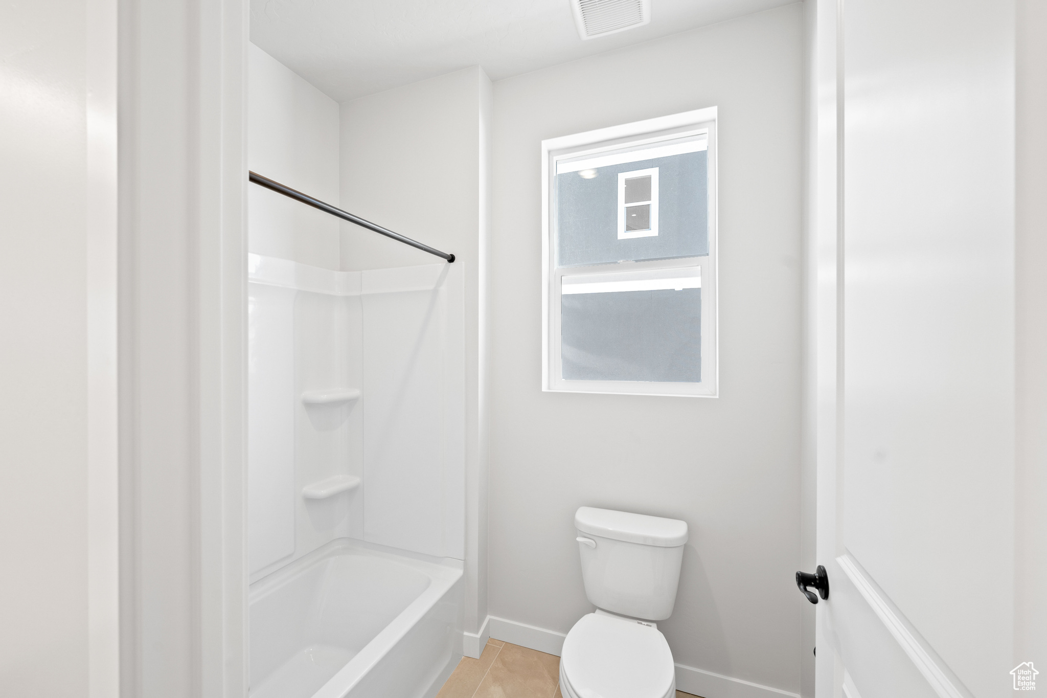 Full bath featuring tub / shower combination, visible vents, baseboards, and toilet